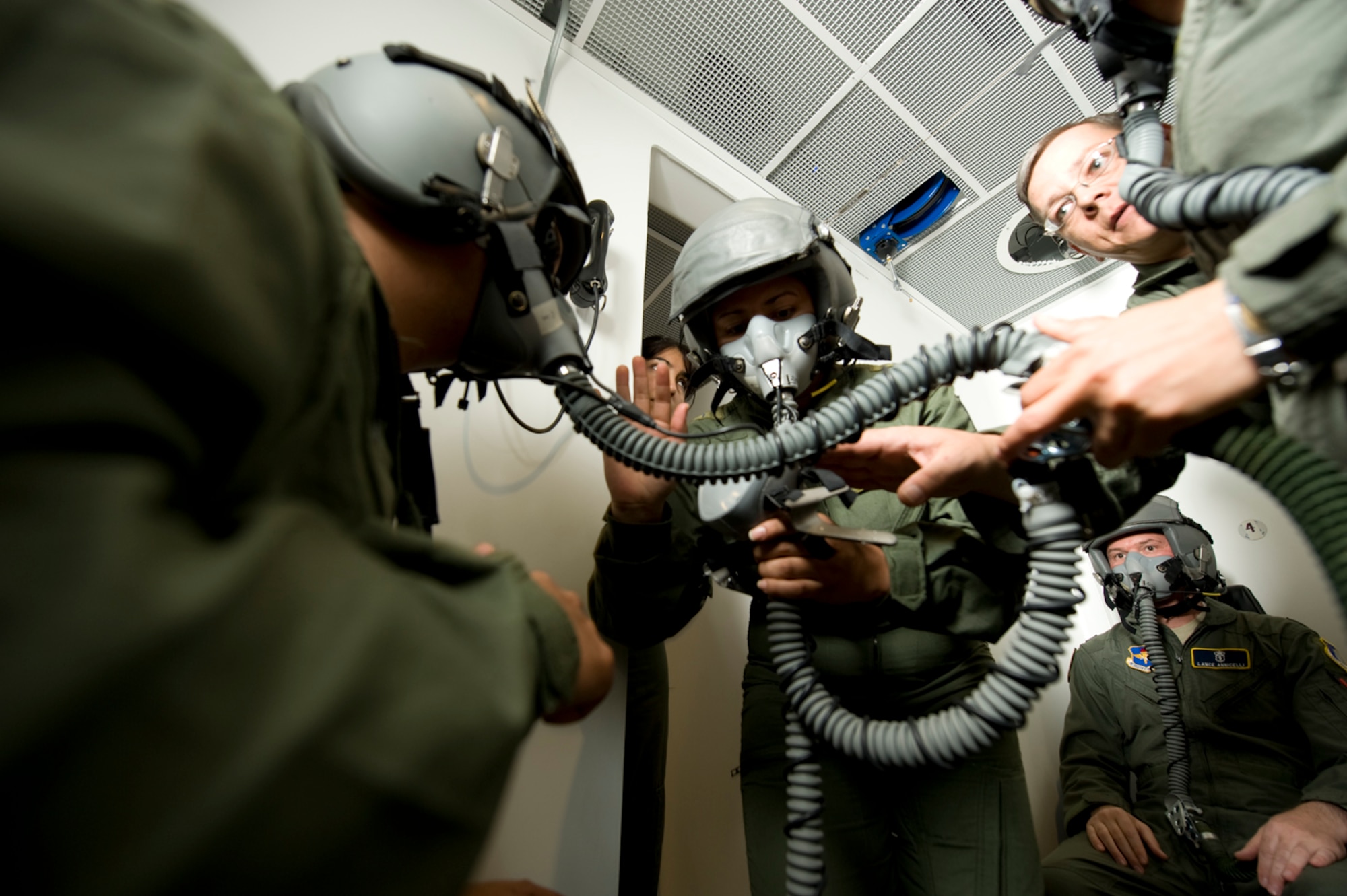 Inside the altitude chamber, Colombian and U.S. crewmembers make final recommendations to students who are preparing for a chamber flight. Their assistance in the process helps reduce the risk of decompression sickness.(Photo by TSgt Samuel Bendet)