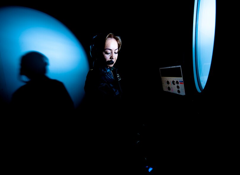 Colombian bacteriologist Maj. Amparo Mora serves as part of the console crew controlling the altitude chamber flight.  The automated chamber system allows for both computer-aided adjustments to the altitude profile and the calibrated pressure.(Photo by TSgt Samuel Bendet)