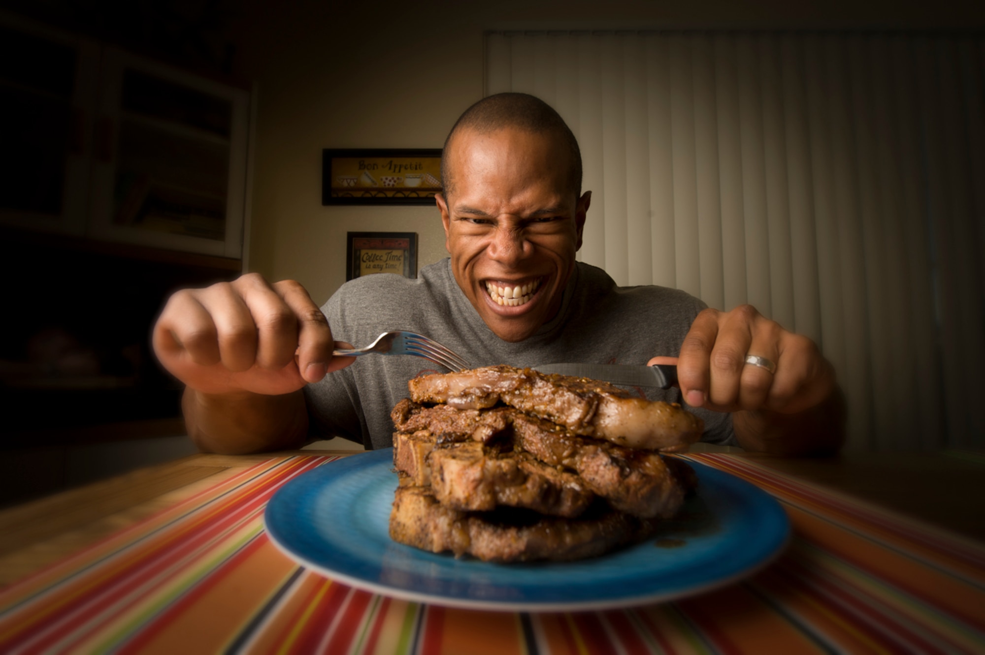 Two T-bone and two rib eye steaks ? nearly four pounds of beef ? contain roughly the amount of protein Henry needs to consume each day to maintain his muscular build. Of course, he doesn?t actually eat that much red meat every day; instead, choosing to take protein supplements, along with a healthy diet, 
to achieve his dietary needs.
(Photo by TSgt Samuel Bendet)