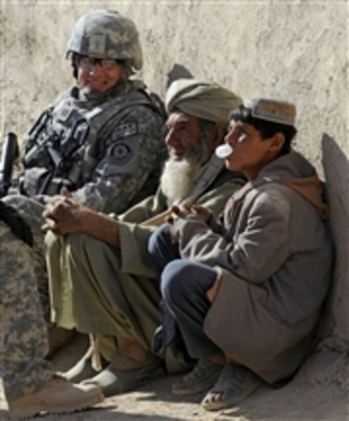 U.S. Air Force Capt. Ryan Weld, an intelligence officer with the Zabul Provincial Reconstruction Team, talks with Afghans during a wroowali, or brotherhood, mission to Bakorzai village, Afghanistan, on Dec. 22, 2010.  Wroowali missions were designed to bring the Afghan people closer to their government.  DoD photo by Staff Sgt. Brian Ferguson, U.S. Air Force.  (Released)