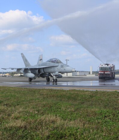 Marine All-Weather Fighter Attack Squadron 242 F/A-18 Hornet number 02 goes through a shower of water after the last III Marine Expeditionary Force flight of Lt. Gen. Terry G. Robling here Dec. 28.
