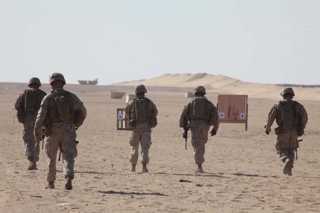 Marines with Company L, Battalion Landing Team 3/8, 26th Marine Expeditionary Unit, walk down to the targets to examine their shot groups during a battle sight zero firing exercise aboard Camp Buehring, Kuwait, Dec. 28, 2010. Elements of 26th MEU disembarked the ships of Kearsarge Amphibious Ready Group to conduct sustainment training in various Middle Eastern and African countries. (Official USMC photo by Sgt. Jesse J. Johnson/ Released) ::r::::n::