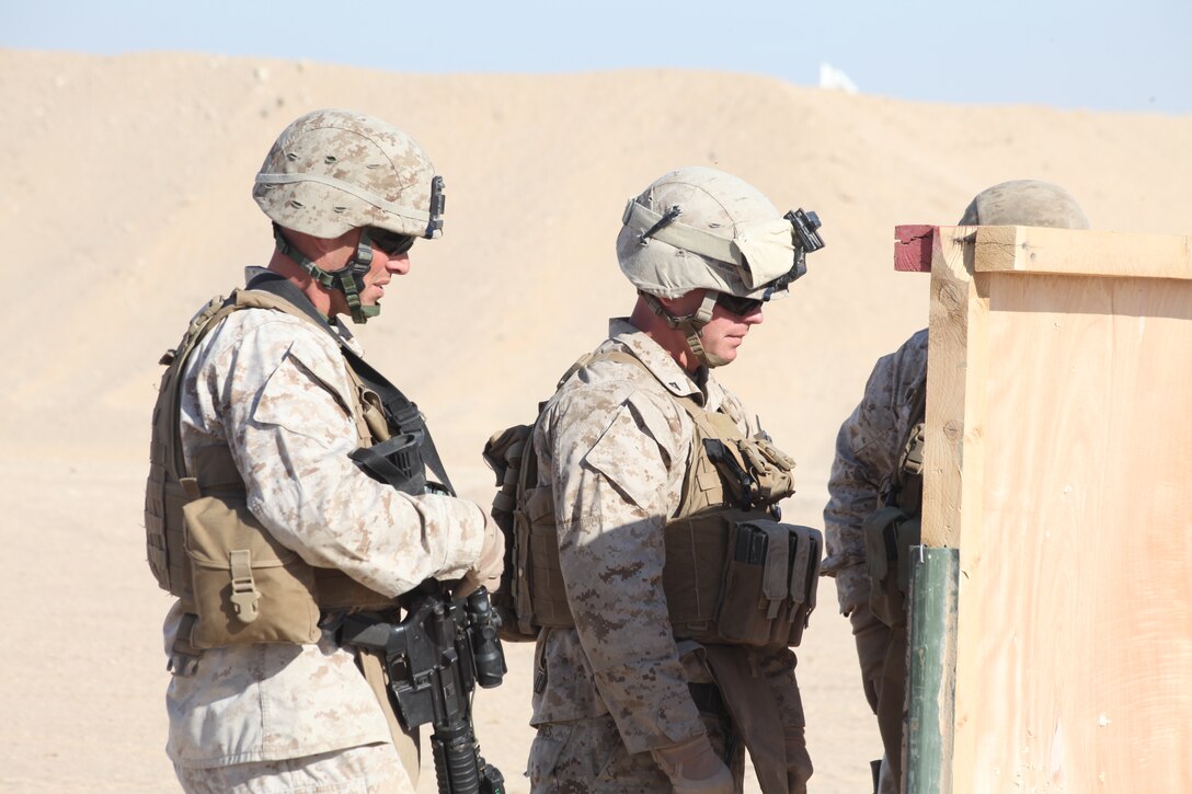 Sergeant Jason M. Carlson, left, with Amphibious Assault Vehicle Platoon, and Lance Cpl. Michael K. Karnes, a infantry man, both with Company L, Battalion Landing Team 3/8, 26th Marine Expeditionary Unit, check the shot groups during a battle sight zero firing exercise aboard Camp Buehring, Kuwait, Dec. 28, 2010. Elements of 26th MEU disembarked the ships of Kearsarge Amphibious Ready Group to conduct sustainment training in various Middle Eastern and African countries. (Official USMC photo by Sgt. Jesse J. Johnson/ Released) ::r::::n::
