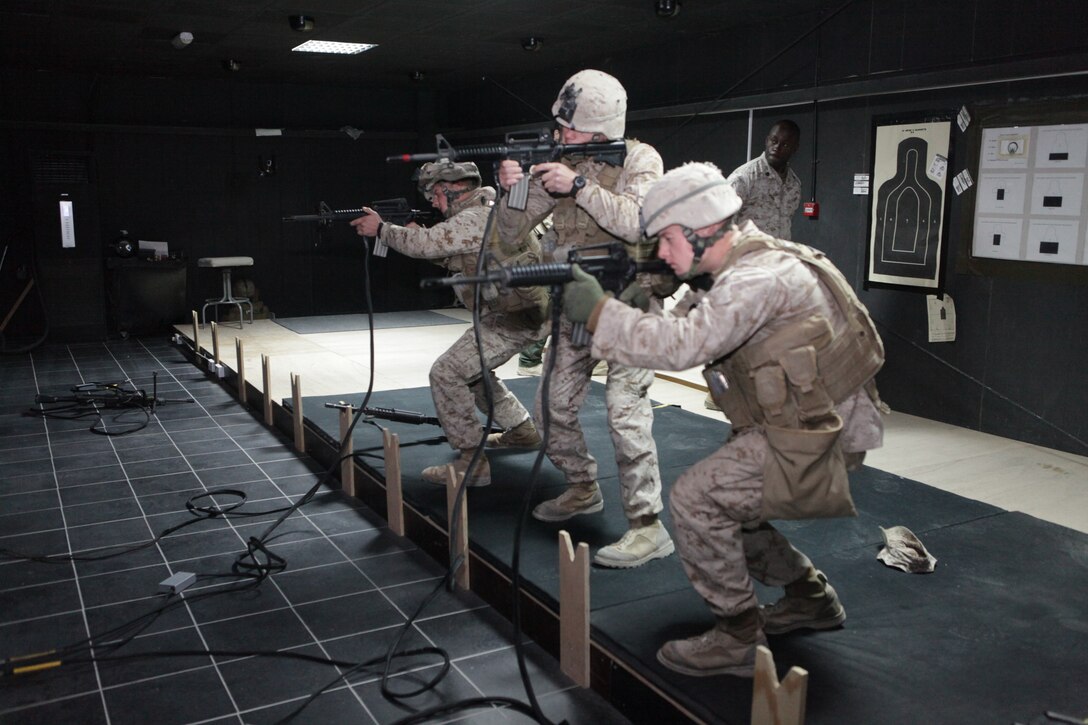 CAMP BUEHRING, Kuwait (Dec. 28, 2010) Marines with Fox Battery 2/12, Battalion Landing Team 3/8, 26th Marine Expeditionary Unit (MEU), fire M16A2 service rifle simulator during an Indoor Simulated Marksmanship Trainer session at Camp Buehring, Kuwait, Dec. 28. Elements of 26th MEU debarked the ships of Kearsarge Amphibious Ready Group to conduct sustainment training. (USMC photo by Lance Cpl. Santiago G. Colon Jr./Released)