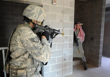 A cadre member portraying an enemy combatant is caught in the cross hairs of an Airman during a traning demonstration at Camp Bullis, Texas, Oct. 20. Commanders with Air Education and Training Command were on hand to witness and also participate in the training, which is provided to Air Force personnel assigned to convoy duty in Iraq and Afghanistan. The cadre, who portray enemy combatants, are usually Airmen who have returned from a deployment. (U.S. Air Force photo/David Terry)