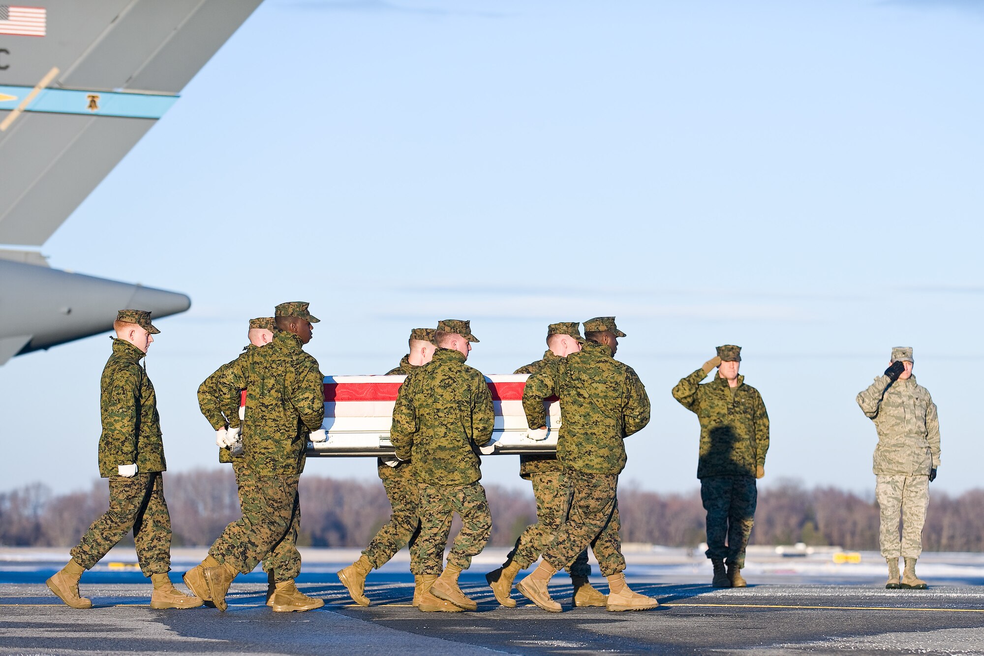 A U.S. Marine Corps carry team transfers the remains of Marine Sgt. Garrett A. Misener, of Cordova, Tenn., at Dover Air Force Base, Del., Dec. 28, 2010. Misener was assigned to the 2nd Battalion, 9th Marine Regiment, 2nd Marine Division, II Marine Expeditionary Force, Camp Lejeune, N.C.  (U.S. Air Force photo/Roland Balik)