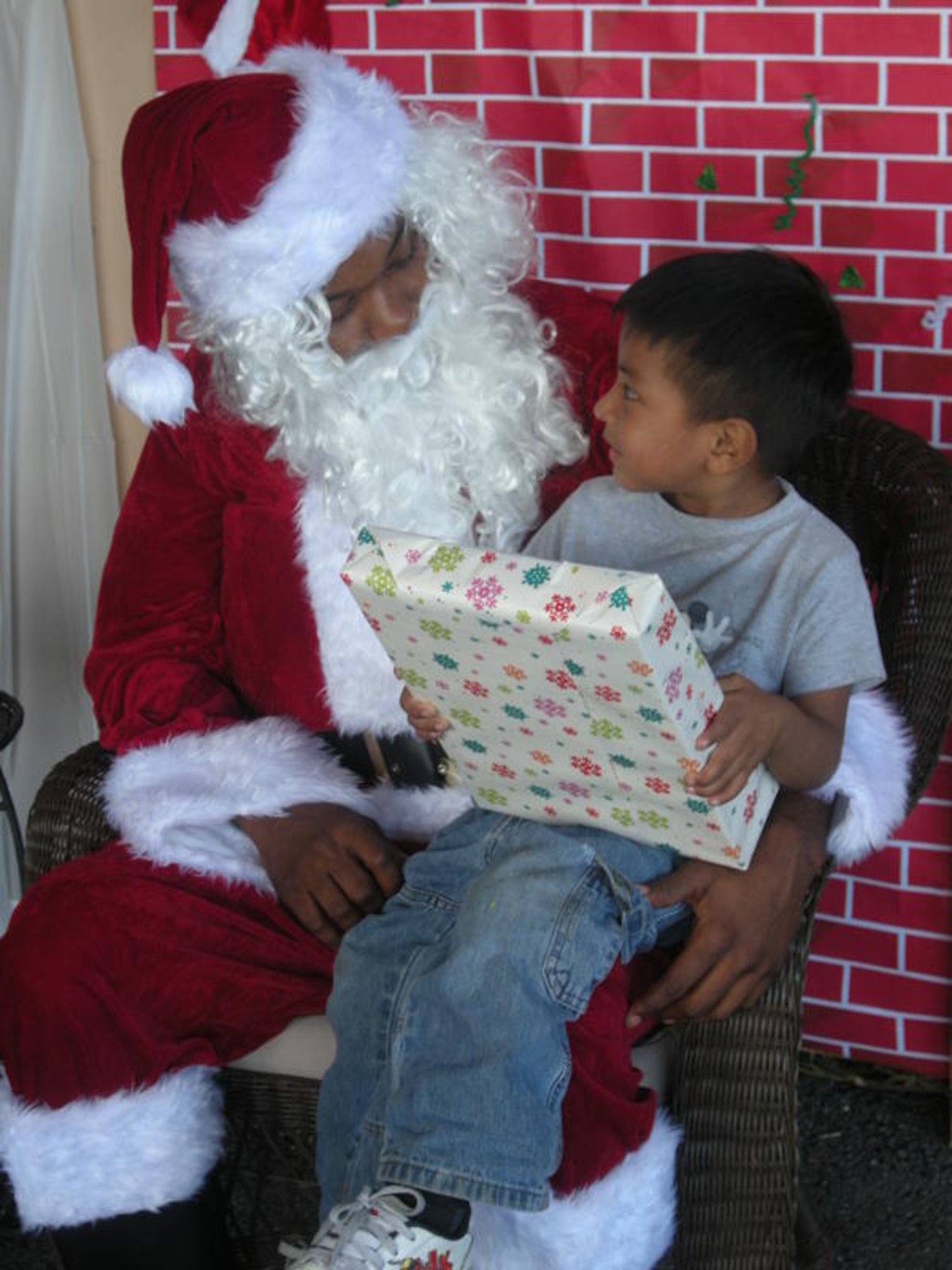Air Force Staff Sgt. Richardson, assigned to the Special Operations Command South intelligence section, volunteered to dress up as Santa Claus and hand out presents during a toy giveaway event sponsored by the Homestead Police Department to benefit the less fortunate children across the Homestead area, Dec 21. (U.S. Army photo by Sgt. 1st Class Alex Licea) 