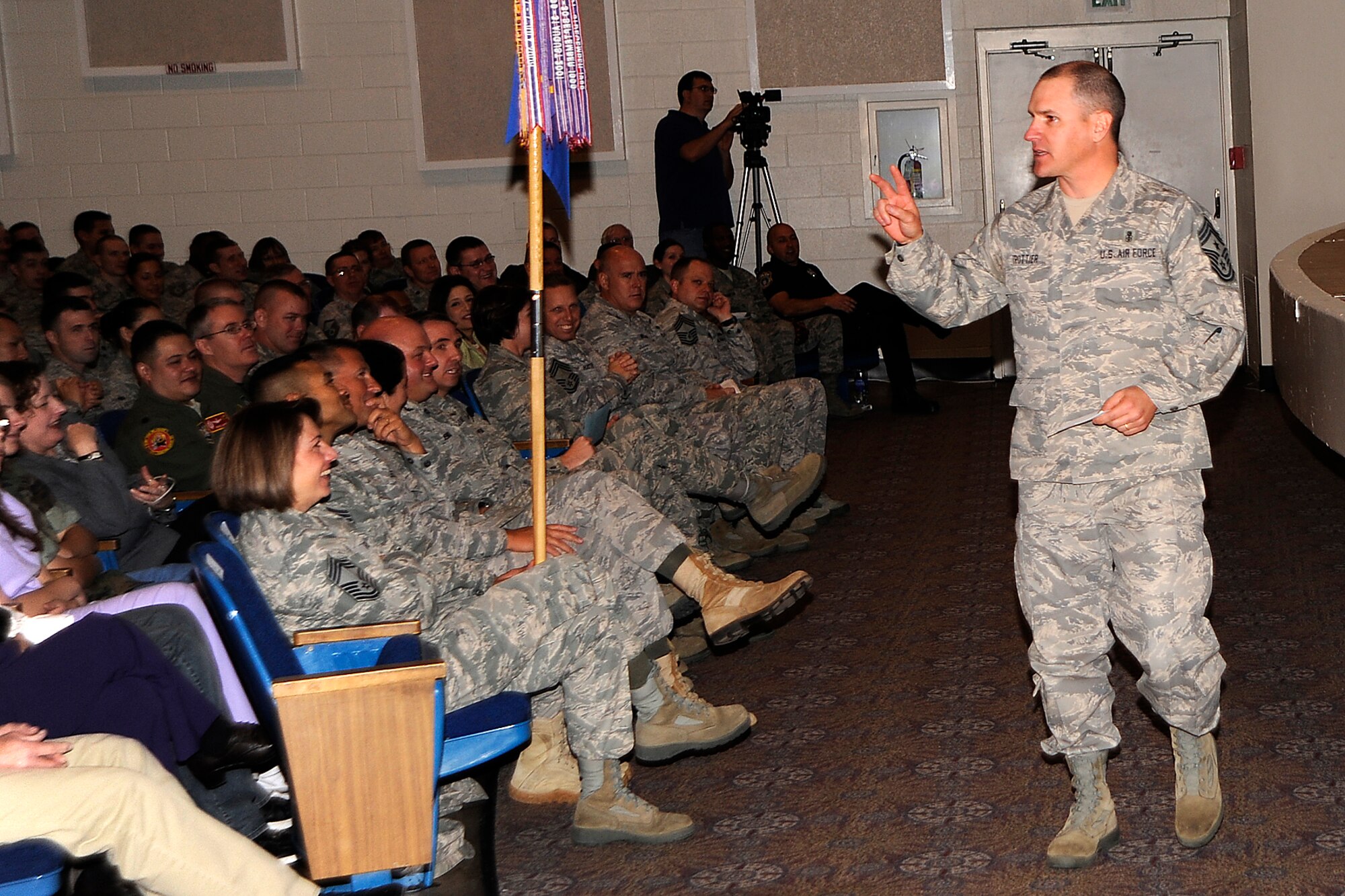 Chief Master Sgt. Thomas Trottier, who was named 21st Space Wing command chief in November, introduces himself at the Dec. 14 commander’s call in the Peterson Air Force Base auditorium. As command chief he advises Col. Stephen N. Whiting, 21st SW commander, on issues affecting the health, welfare, morale and utilization of an enlisted force of 3,200 personnel. (U.S. Air Force photo/Dennis Howk)