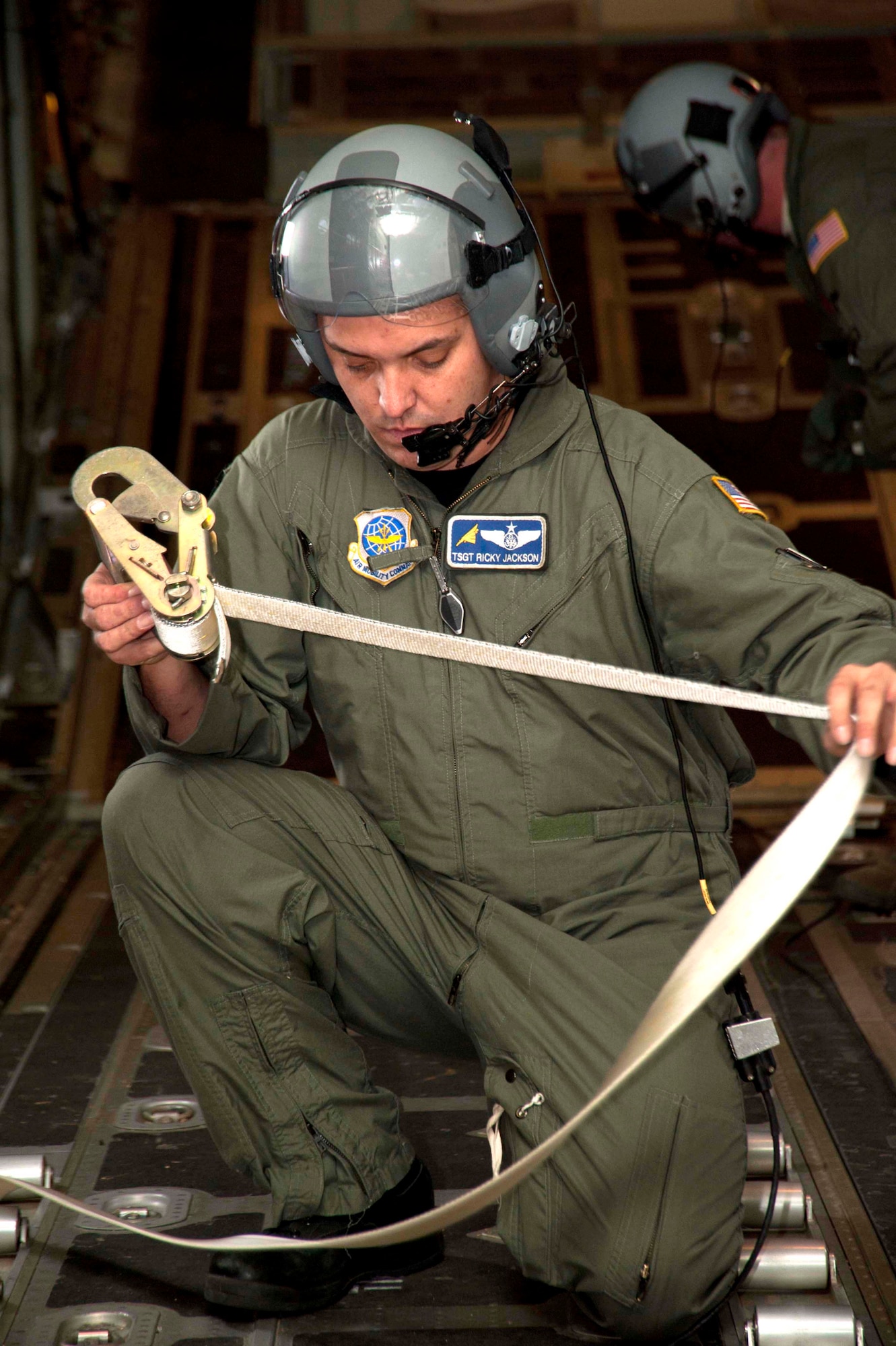 Tech. Sgt. Ricky Jackson, 345th Airlift Squadron loadmaster, wraps up a cargo strap as he secures the back bay of a C-130J-30 strech model aircraft after an airdrop exercise. Reservists with the 815th AS and active-duty members from the 345th AS train side-by-side as they prepare for an upcoming deployment early next year in support of overseas contingencies in Southwest Asia. (U.S. Air Force photo by Tech. Sgt. Ryan Labadens)