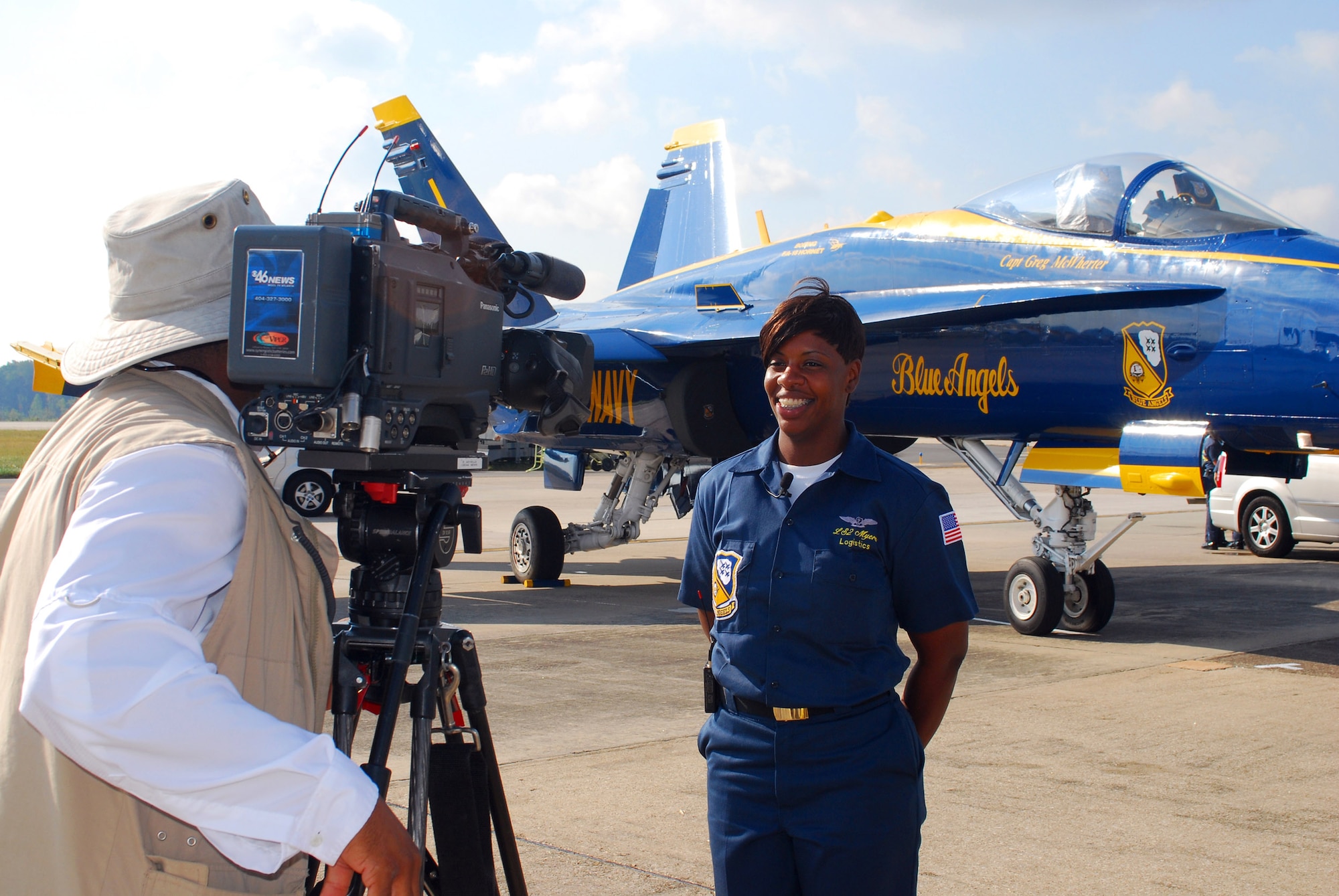 Blue Angels team member LS2 Stacey Myers, a native of Columbus, Ga., is interviewed by local media shortly after arriving at Dobbins Air Reserve Base Oct. 14.  The Blue Angels will fly their exciting demonstration during the Wings Over Atlanta 2010 Air Show .  (U.S. Air Force photo/ Brad Fallin)