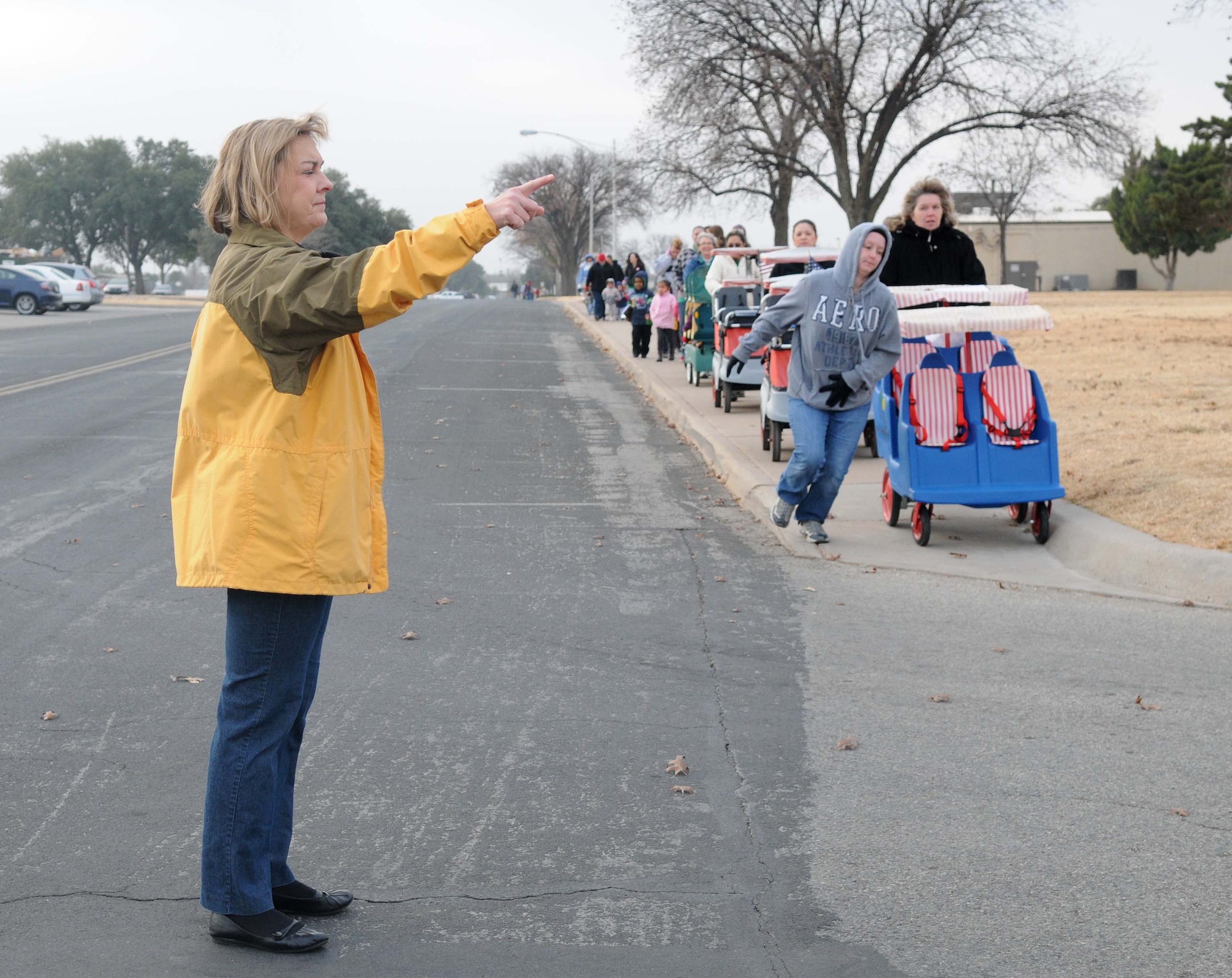 GOODFELLOW AFB, Texas - Dennisse Jones, Director of the Child Development Center, directs traffic during an evacuation exercise at Goodfellow AFB, TX, 22 Dec.  The CDC evacuated all of the children to their alternate location to practice emergency procedures. (U.S. Air Force photo/Staff Sgt. Heather Rodgers)
