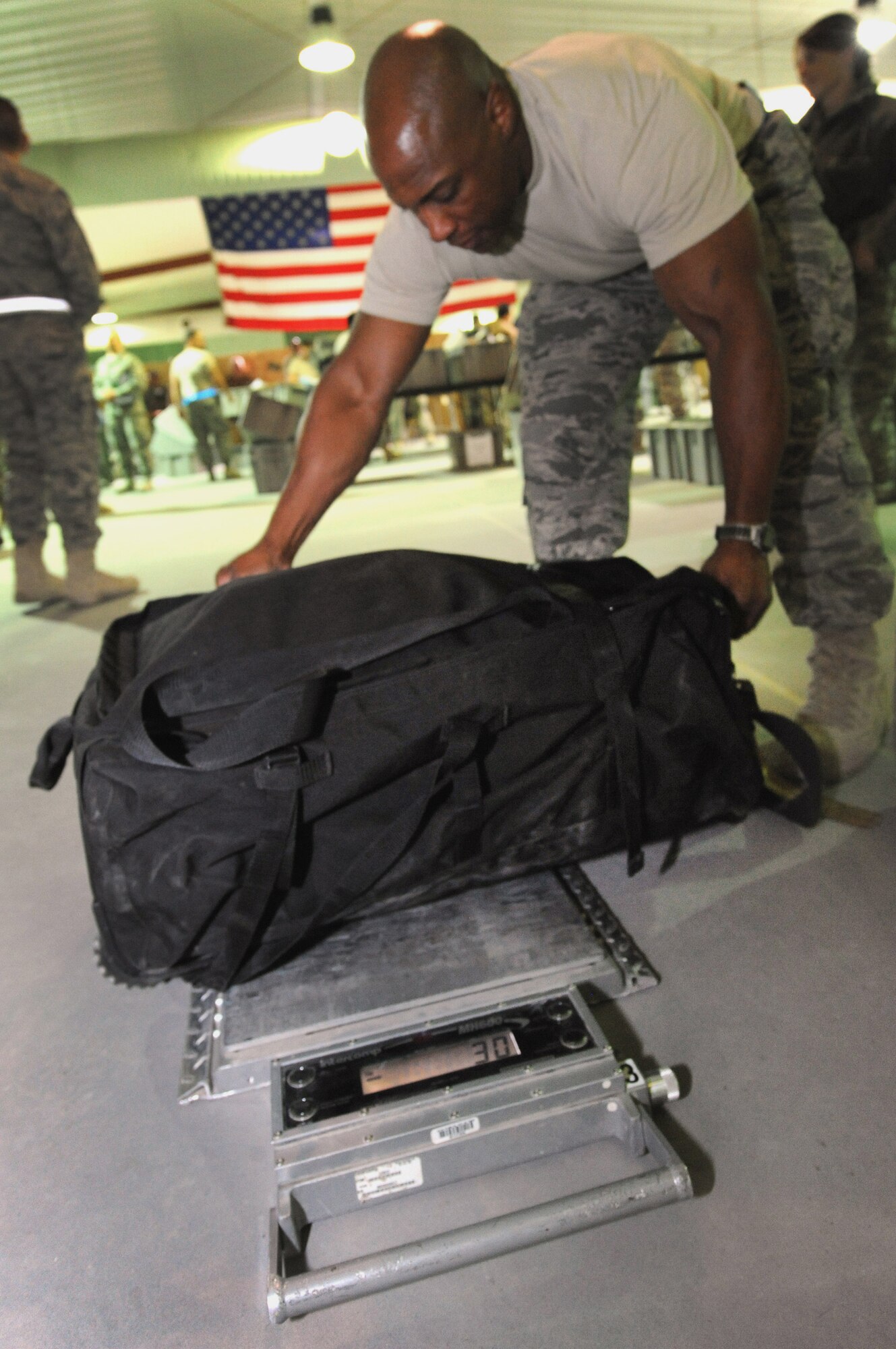 Master Sgt. Sean Abner checks the weight of service member's luggage Dec. 21, 2010, in Southwest Asia. Officials from the 386th Air Expeditionary Wing were able to cut down the redeployment process with the implementation of an all-Air Force customs process, a first in the Air Force Central Command area of responsibility. (U.S. Air Force photo/Senior Airman Cynthia Spalding)
