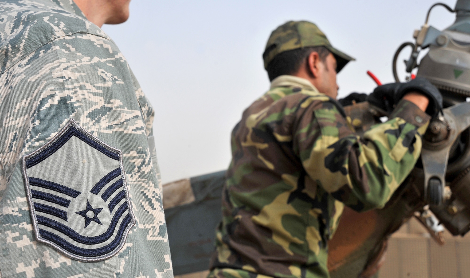 Master Sgt. Lawerence Shaw watches as an Iraqi Army Aviation Command soldier adjusts the tail rotor of a Mi-17 helicopter Dec. 11, 2010, in Taji, Iraq. Sergeant Shaw is a 721st Air Expeditionary Advisory Squadron maintenance air adviser. Air advisers with the 721st AEAS work with AAC members at Taji to advise and assist them in building a safe, self-sustaining Iraqi rotary-wing force. (U.S. Air Force photo/Senior Airman Andrew Lee)
