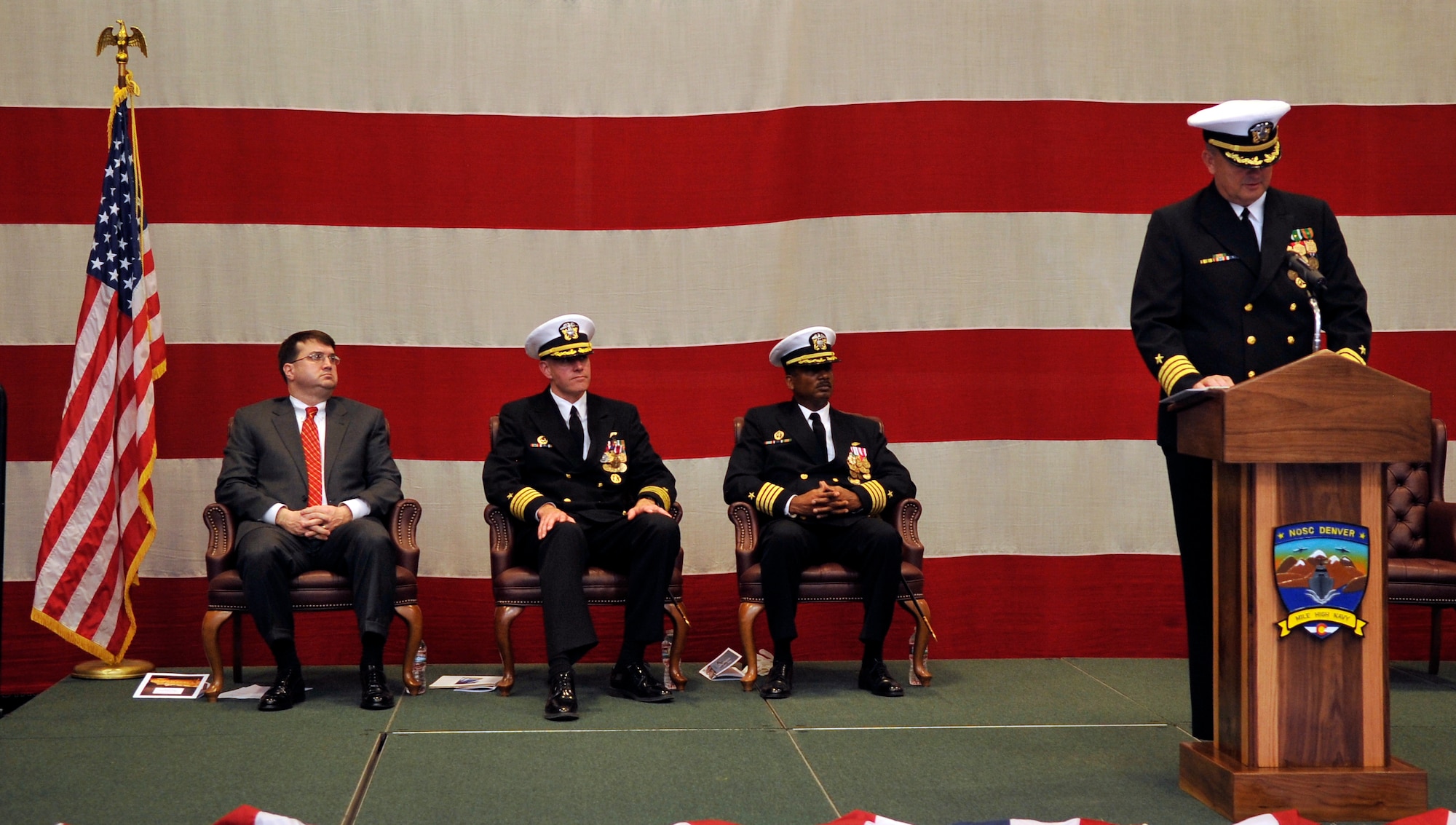 BUCKLEY AIR FORCE BASE, Colo. -- Capt. Leith Wimmer, Navy Operational support Center Denver Commanding officer reads off the accomplishments of Capt. Shawn Grenier, Navy Operational support Center Denver on Dec. 15, 2010.(U.S. Air Force photo by Airman 1st Class Paul Labbe.)
