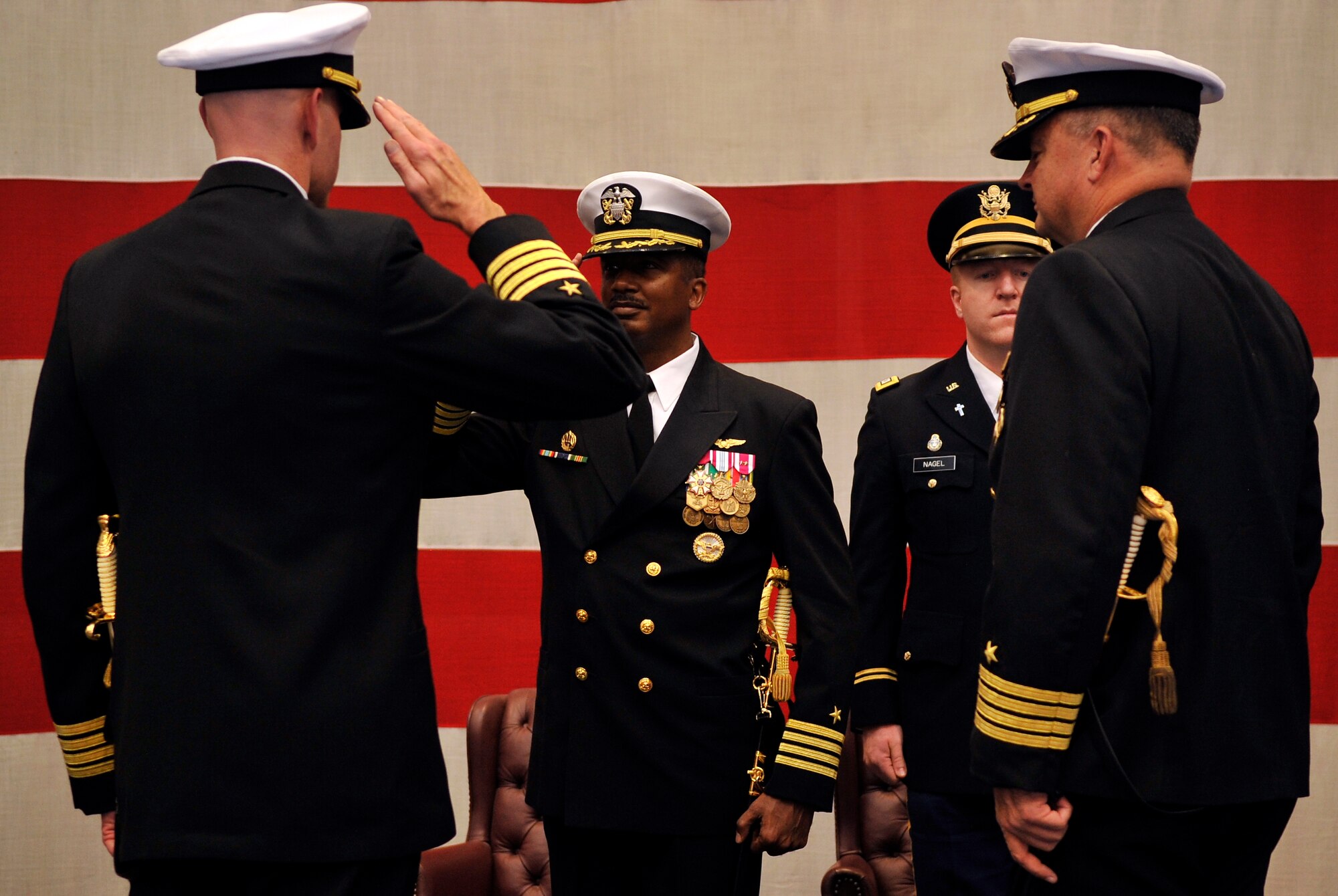 BUCKLEY AIR FORCE BASE, Colo. -- Capt. Shawn Grenier, Former Commanding Officer of Navy Operational support Center Denver salutes Capt.Marco Cromartie Commanding Officer Navy Region Southwest Reserve Component Command on Dec. 15, 2010. (U.S. Air Force photo by Airman 1st Class Paul Labbe.) 
