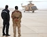 Two Iraqi Army Aviation Command soldiers observe an Mi-17 helicopter as its crew prepares to take off Dec. 15, 2010, in Taji, Iraq. Air advisers with the 721st AEAS work with AAC members at Taji to advise and assist them in building a safe, self-sustaining Iraqi rotary-wing force. (U.S. Air Force photo/Senior Airman Andrew Lee)