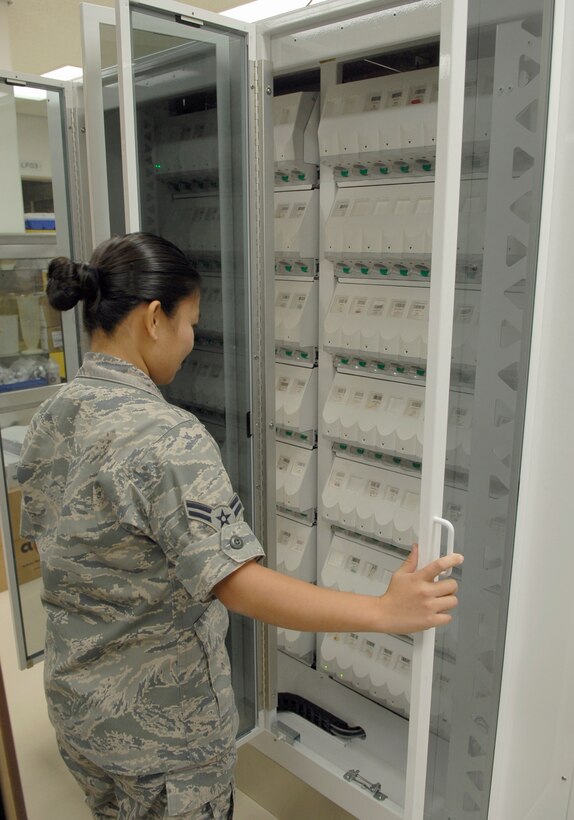 Airman 1st Class Roma Terry reviews the different types of medication the PharmASSIST ROBOTx is stocked with Dec. 10, 2010, at Kadena Air Base, Japan. The PharmASSIST can store anywhere from 70  to 140 prescription dispensers at one time based on pharmacy volume, budget and requirements. Airman Terry is a pharmacy technician with the 18th Medical Support Squadron. (U.S. Air Force photo/Airman 1st Class Tara A. Williamson)
