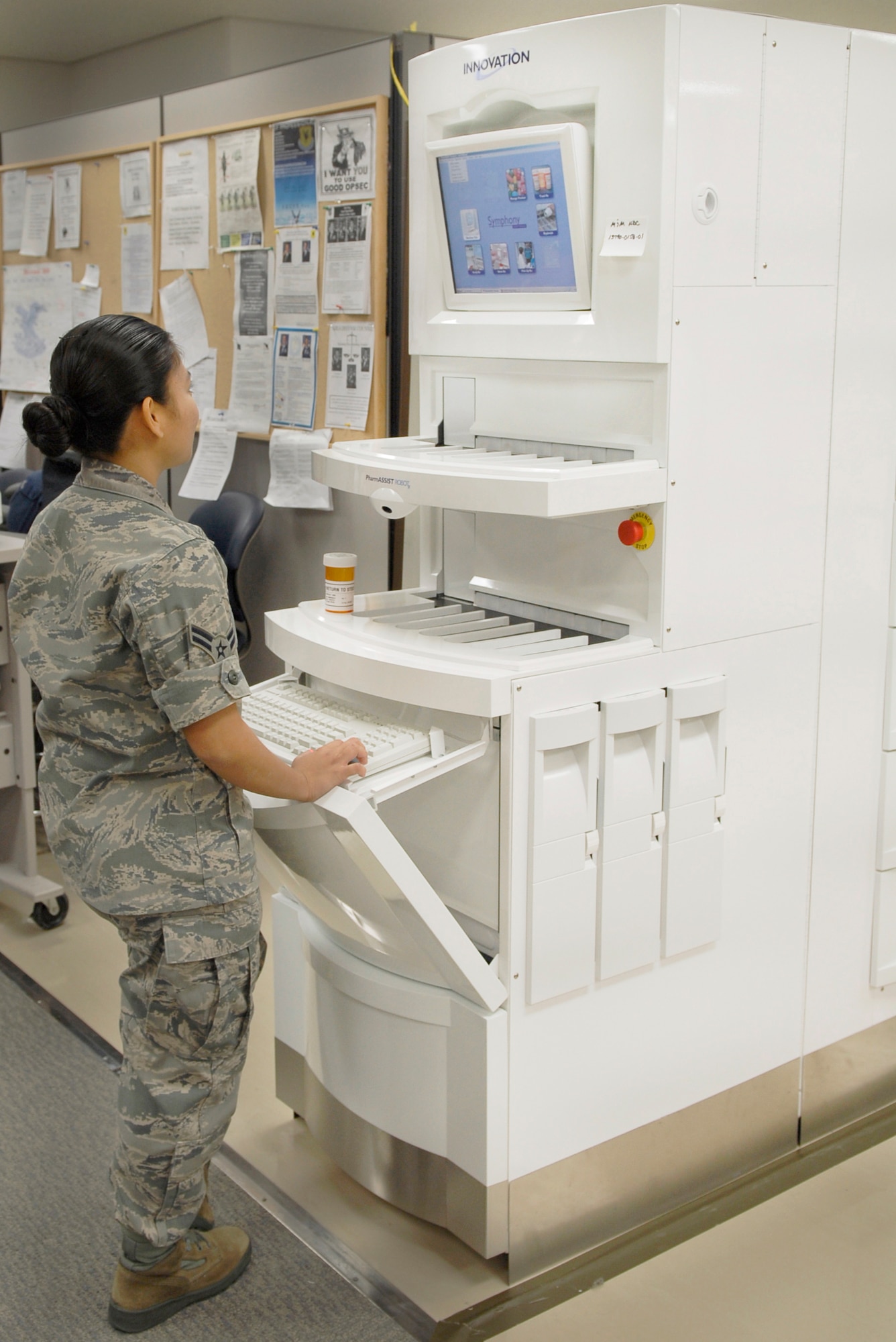 Airman 1st Class Roma Terry begins running a check on the new pharmacy robot Dec. 10, 2010, at Kadena Air Base, Japan. The PharmASSIST ROBOTx has established quality checkpoints throughout the pharmacy by employing bar code scanning, digital images of medications and original paper prescriptions, and protocols at every stage of the prescription filling process. Airman Terry is a pharmacy technician with the 18th Medical Support Squadron. (U.S. Air Force photo/Airman 1st Class Tara A. Williamson)