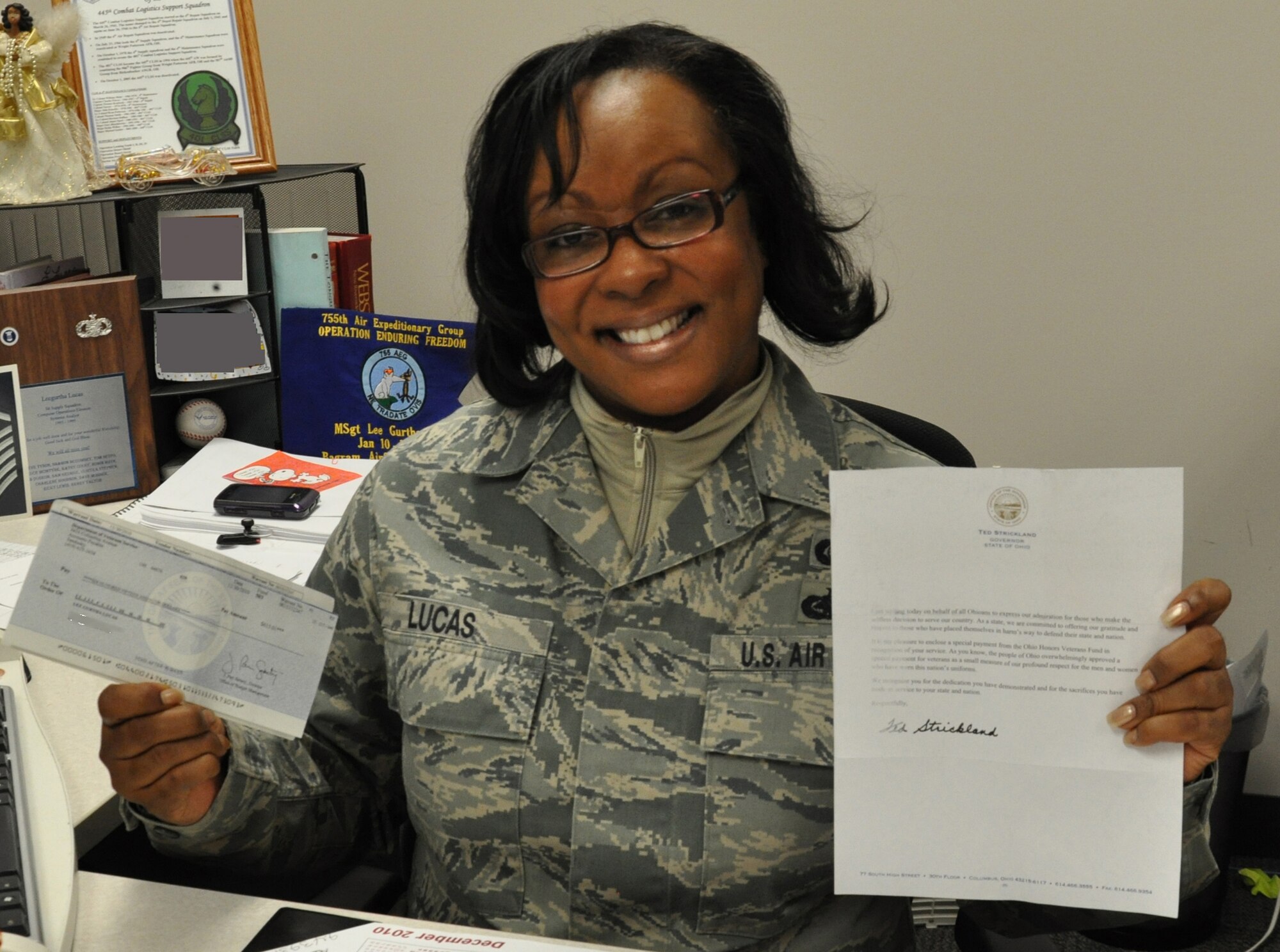 WRIGHT-PATTERSON AIR FORCE BASE, Ohio - Master Sgt. Leegurtha Lucas, 445th Force Support Squadron, shows off her check and letter from the Governor of the State of Ohio Dec. 3 she received through the Ohio Veterans Bonus program.  (U.S. Air Force photo/Senior Airman Mikhail Berlin)