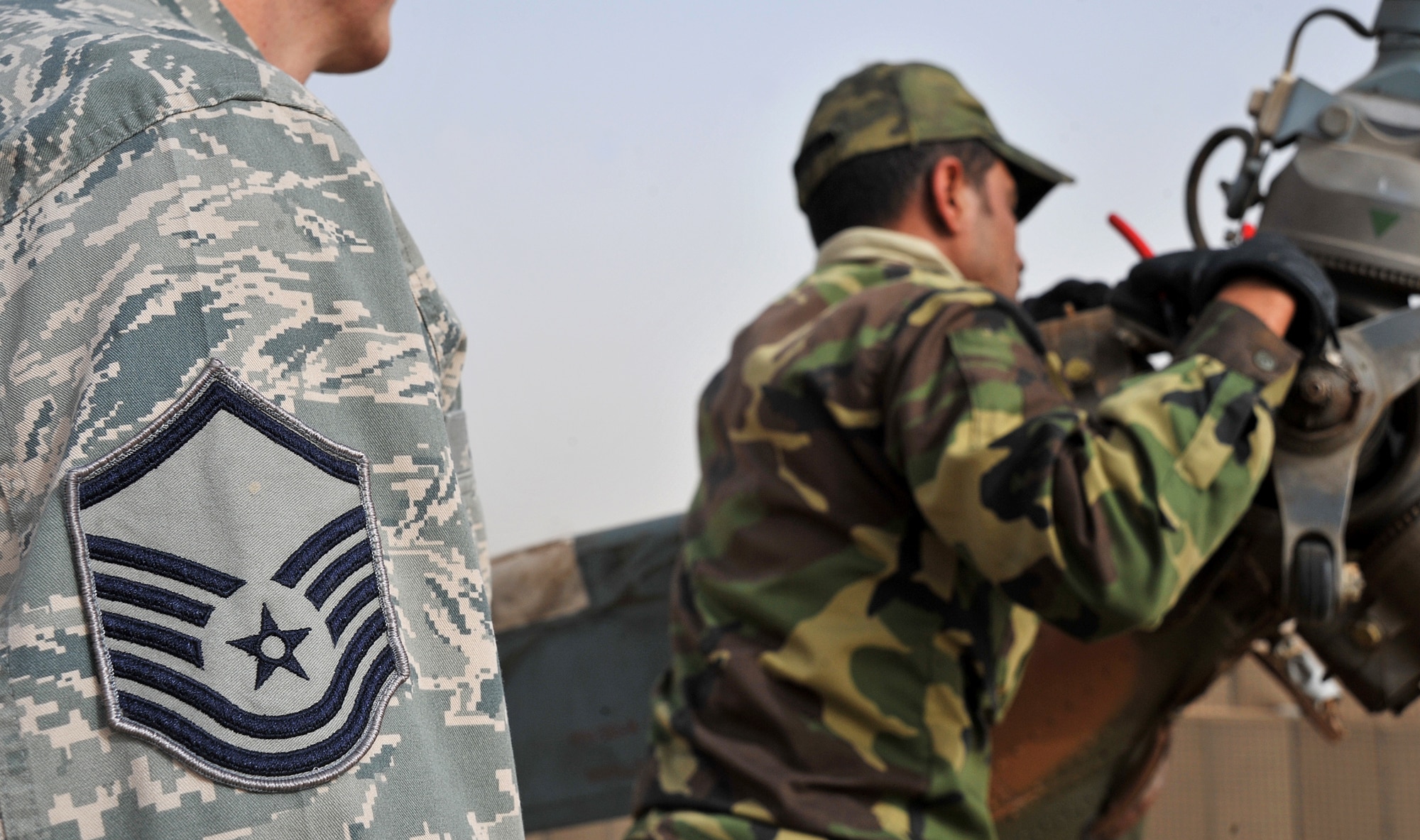 Master Sgt. Laurence Shaw, 721st Air Expeditionary Advisory Squadron maintenance air advisor, observes as an Iraqi Army Aviation Command soldier adjusts the tail rotor of a Mi-17 helicopter Dec. 11, 2010, in Taji, Iraq. 721st AEAS air advisors work with the AAC at Taji to advise and assist them in building a safe, self-sustaining Iraqi rotary-wing force. (U.S. Air Force photo/Senior Airman Andrew Lee)