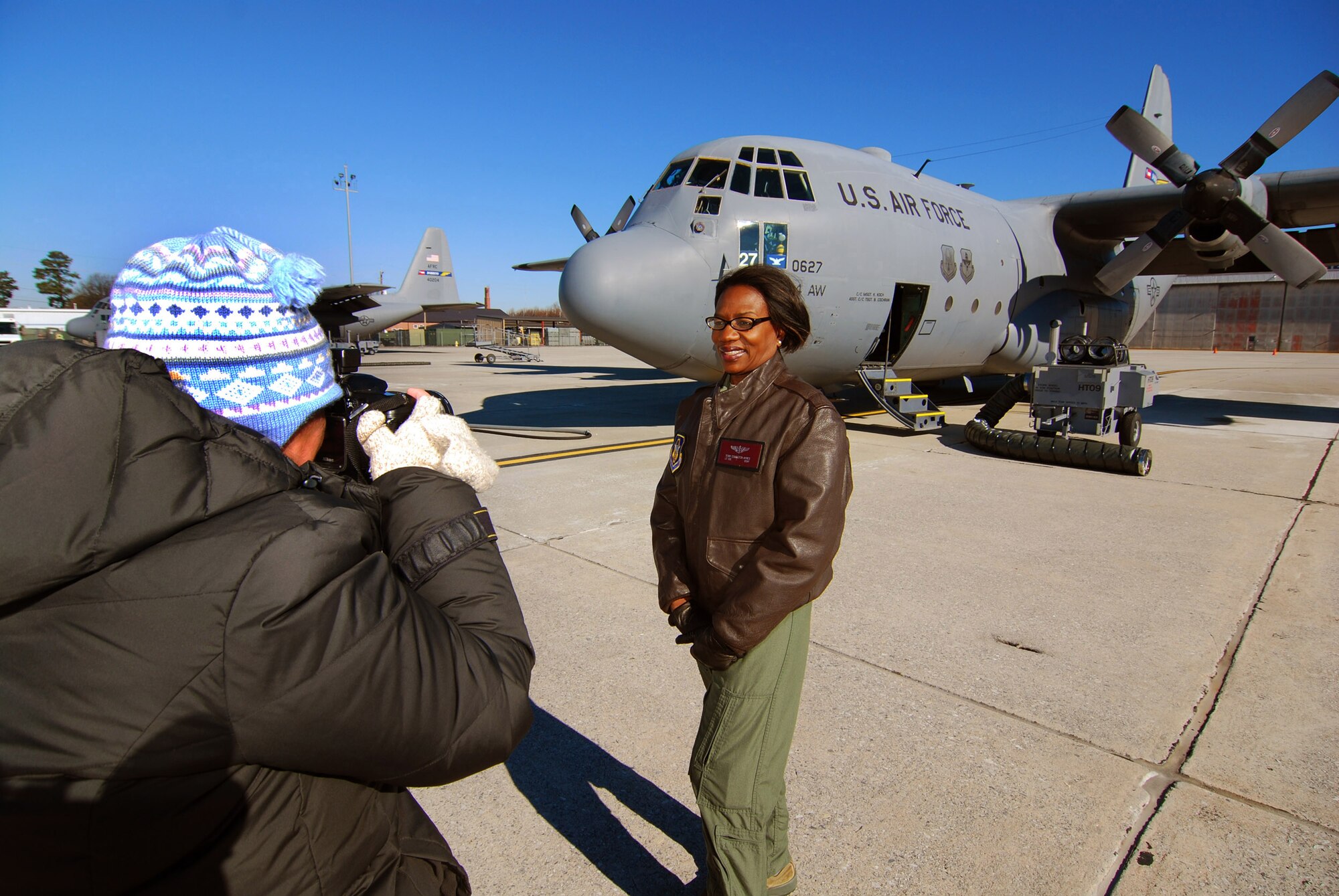 Lt. Col. Teresa C. Ayres, an Air Force Reserve flight nurse with the 514th Aeromedical Evacuation Squadron poses for a photo by Laura Moon on the flightline in front of a C-130H2 here, Dec. 7.  In civilian life Colonel Ayres is a nurse in the Vascular Institute at WellStar Kennestone Hospital in Marietta and travels to Joint Base McGuire-Dix-Lakehurst, N.J. for her reserve duty.  The Marietta Daily Journal ran an extensive Christmas day front-page story about her service to the community and over 21 years to the nation.  (U.S. Air Force photo/ Brad Fallin)