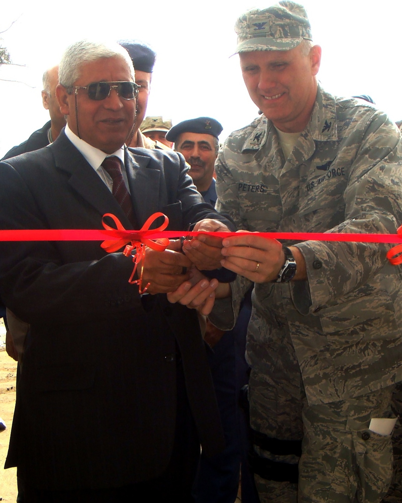 Brigadier General Salah, Iraq Air Force Surgeon General, and Col. Gordon Peters, Iraq Training and Advising Mission Surgeon General, cut the ribbon for a new medical facility at New Al Muthana Air Base Dec. Dec. 11.  The facility has state-of-the-art equipment, technology, and the capability to house patients for extended periods. U.S. Air Force photo, released)