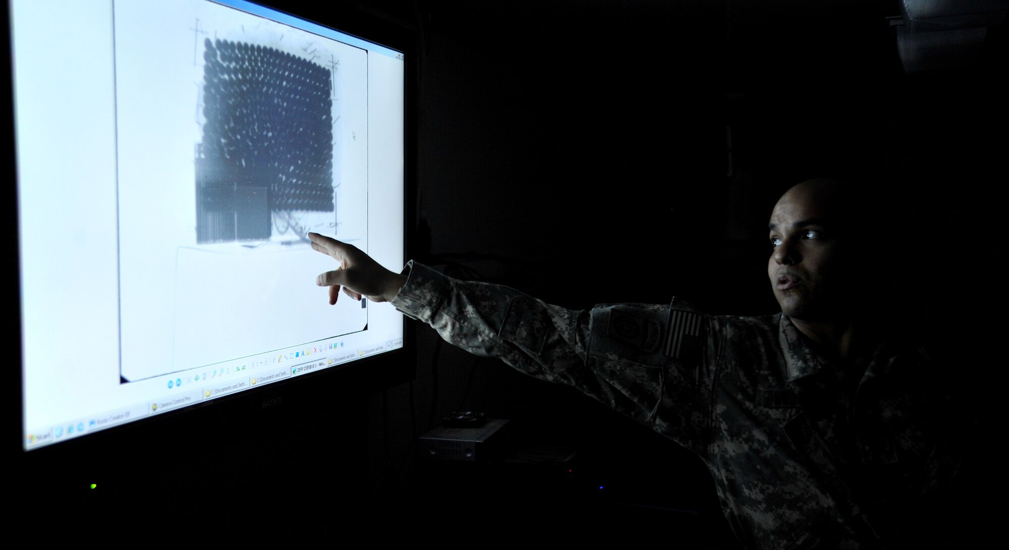 U.S. Army Sgt. Eliot Mendoza, United States Forces-Iraq Combined Joint Task Force Troy’s Combined Explosive Exploitation Cell Triage Laboratory technician, shows an x-ray photograph of an improvised explosive device during a tour Dec. 8, 2010, on Camp Victory, Iraq. One key responsibility of CJTF Troy and CEXC is neutralizing the improvised explosive devices’ threat through collection and exploitation of IED evidence and related intelligence. CJTF Troy is dedicated to countering IEDs and saving lives of Iraqi and joint forces conducting Operation New Dawn. (U.S. Air Force photo by Senior Airman Andrew Lee)