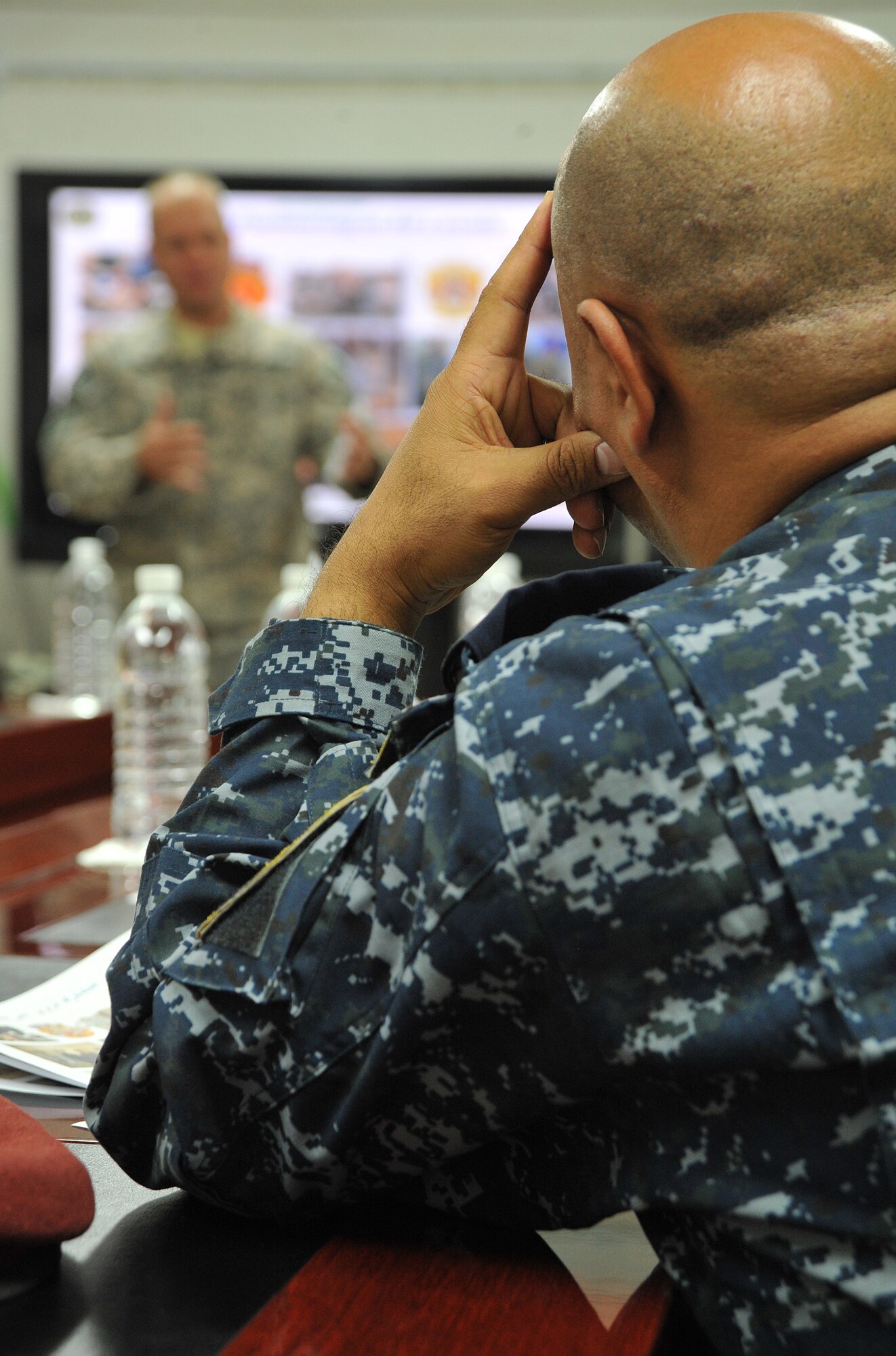 A member of the Iraqi Federal Police listens to a briefing from U.S. Army Capt. Julian Moore, United States Forces-Iraq Combined Joint Task Force Troy’s Advise, Train and Assist Division officer-in-charge, Dec. 2, 2010, before receiving a tour to the task force’s Combined Explosives Exploitation Cell on Camp Victory, Iraq. One key responsibility of CJTF Troy and CEXC is neutralizing the improvised explosive devices’ threat through collection and exploitation of IED evidence and related intelligence. CJTF Troy is dedicated to countering IEDs and saving lives of Iraqi and joint forces conducting Operation New Dawn. (U.S. Air Force photo by Senior Airman Andrew Lee)