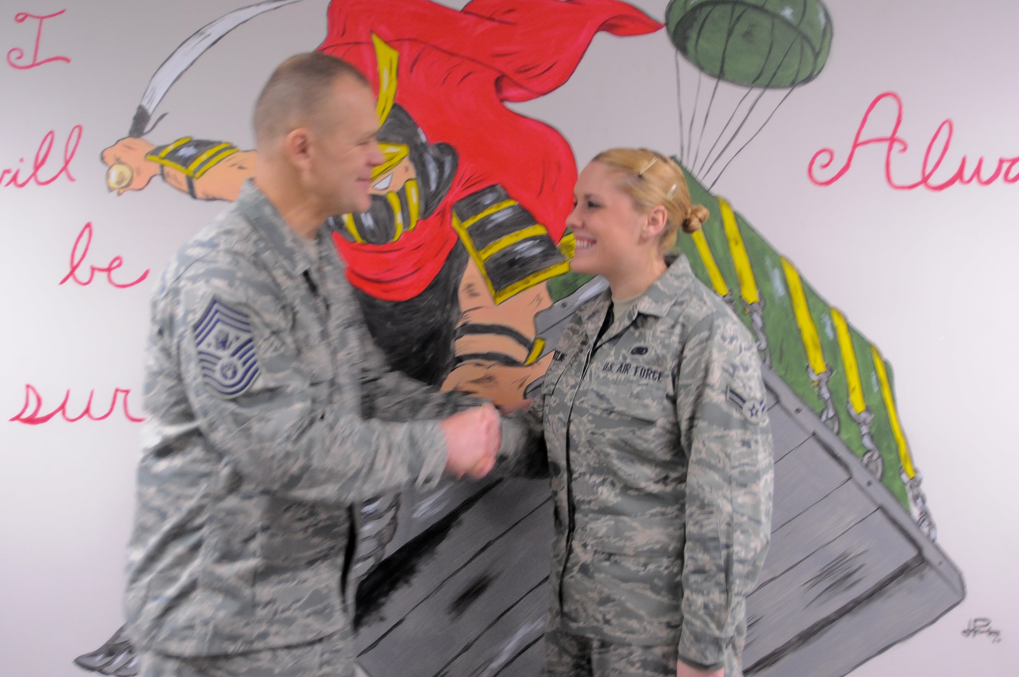 YOKOTA AIR BASE, Japan -- Chief Master Sgt. of the Air Force James Roy presents his coin to Airman 1st Class Amanda Wentling, 374th Logistic Readiness Squadron individual protective equipment apprentice, for her work during the 2010 Winter Dorm Storm. Chief Roy and his wife, Paula, visited Yokota as part of their tour of the Pacific. (U.S. Air Force photo/ Airman 1st Class Katrina R. Menchaca)