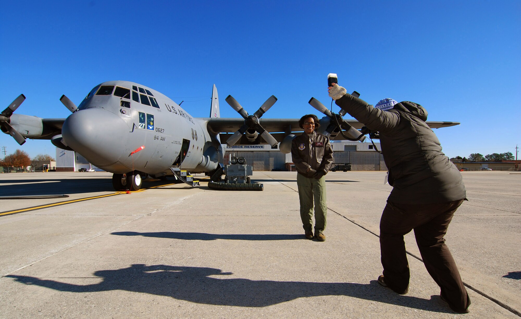 Lt. Col. Teresa C. Ayres, an Air Force Reserve flight nurse with the 514th Aeromedical Evacuation Squadron poses for a photo by Laura Moon on the flightline in front of a C-130H2 here, Dec. 14.  In civilian life Colonel Ayres is a nurse in the Vascular Institute at WellStar Kennestone Hospital in Marietta and travels to Joint Base McGuire-Dix-Lakehurst, N.J. for her reserve duty.  The Marietta Daily Journal ran an extensive Christmas day front-page story about her service to the community and over 21 years to the nation.  (U.S. Air Force photo/ Brad Fallin)