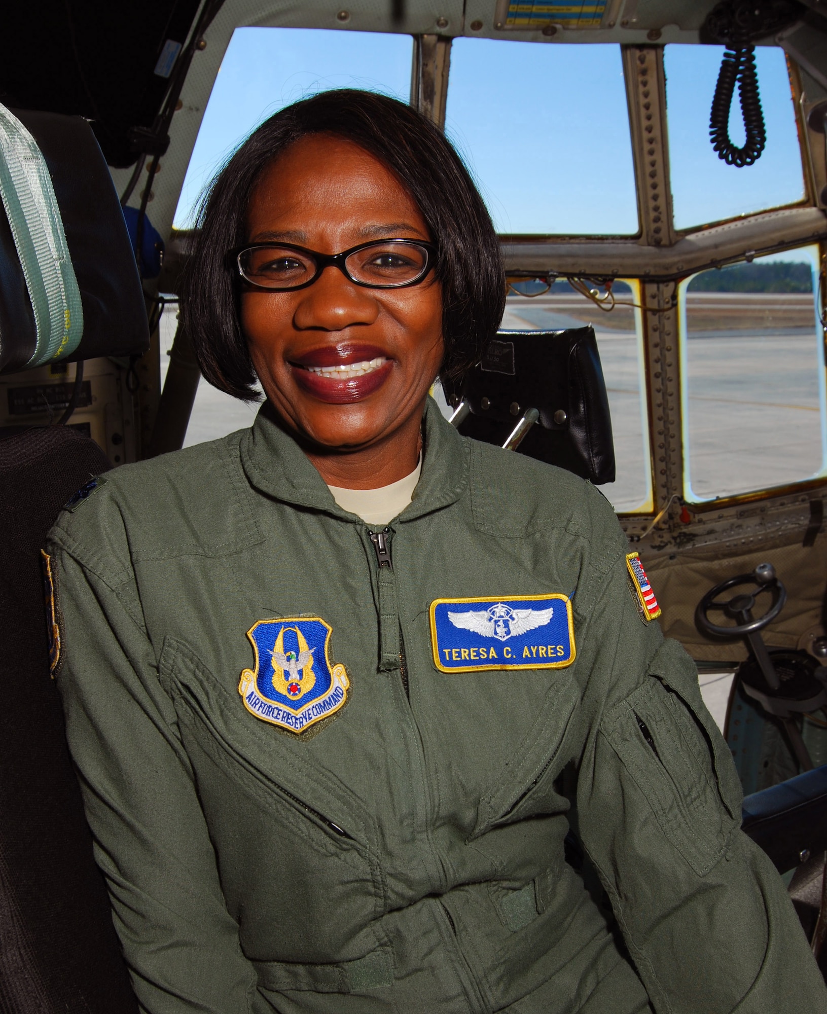 Lt. Col. Teresa C. Ayres, an Air Force Reserve flight nurse with the 514th Aeromedical Evacuation Squadron in the cockpit of a C-130H2 here, Dec. 14.  In civilian life Colonel Ayres is a nurse in the Vascular Institute at WellStar Kennestone Hospital in Marietta and travels to Joint Base McGuire-Dix-Lakehurst, N.J. for her reserve duty.  The Marietta Daily Journal ran an extensive Christmas day front-page story about her service to the community and over 21 years to the nation.  (U.S. Air Force photo/ Brad Fallin)