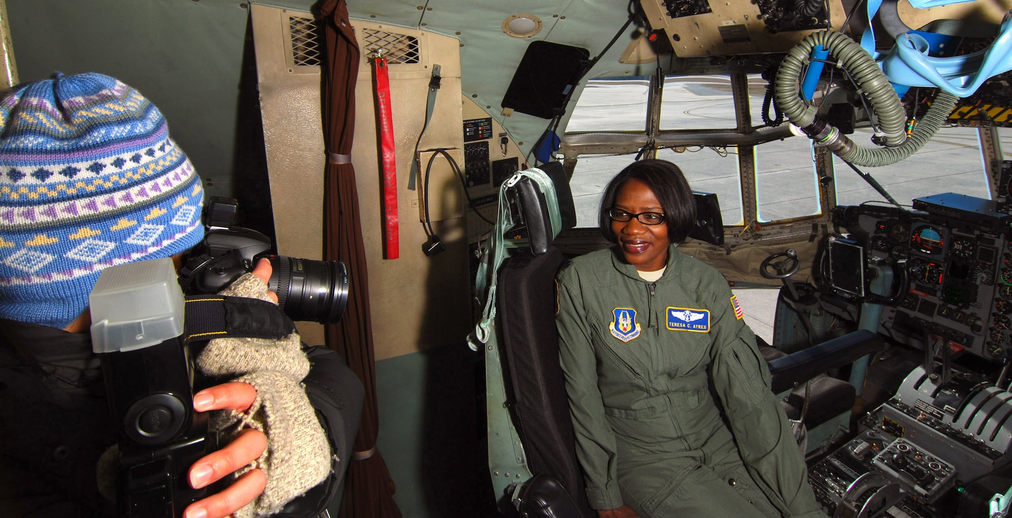Lt. Col. Teresa C. Ayres, an Air Force Reserve flight nurse with the 514th Aeromedical Evacuation Squadron poses for a photo by Laura Moon in the cockpit of a C-130H2 here, Dec. 14.  In civilian life Colonel Ayres is a nurse in the Vascular Institute at WellStar Kennestone Hospital in Marietta and travels to Joint Base McGuire-Dix-Lakehurst, N.J. for her reserve duty.  The Marietta Daily Journal ran an extensive Christmas day front-page story about her service to the community and over 21 years to the nation.  (U.S. Air Force photo/ Brad Fallin)