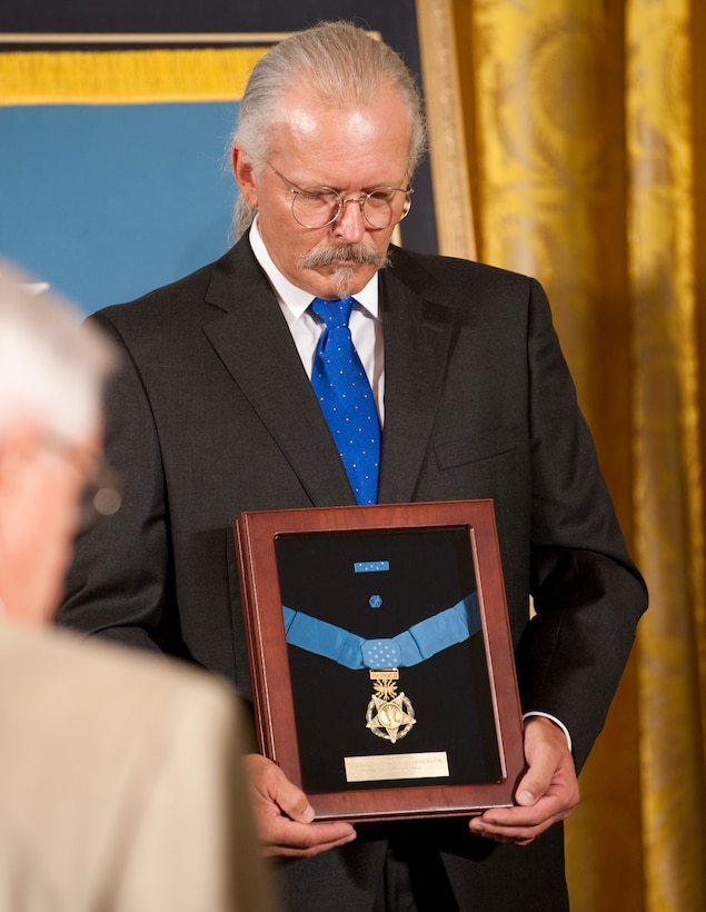 Richard Etchberger holds the Medal of Honor that was awarded to his father, U.S. Air Force Chief Master Sgt. Richard L. Etchberger, during a White House ceremony, Sept. 21, 2010. The elder Etchberger was awarded the medal posthumously;  he was killed in action, March 11, 1968, in Laos.