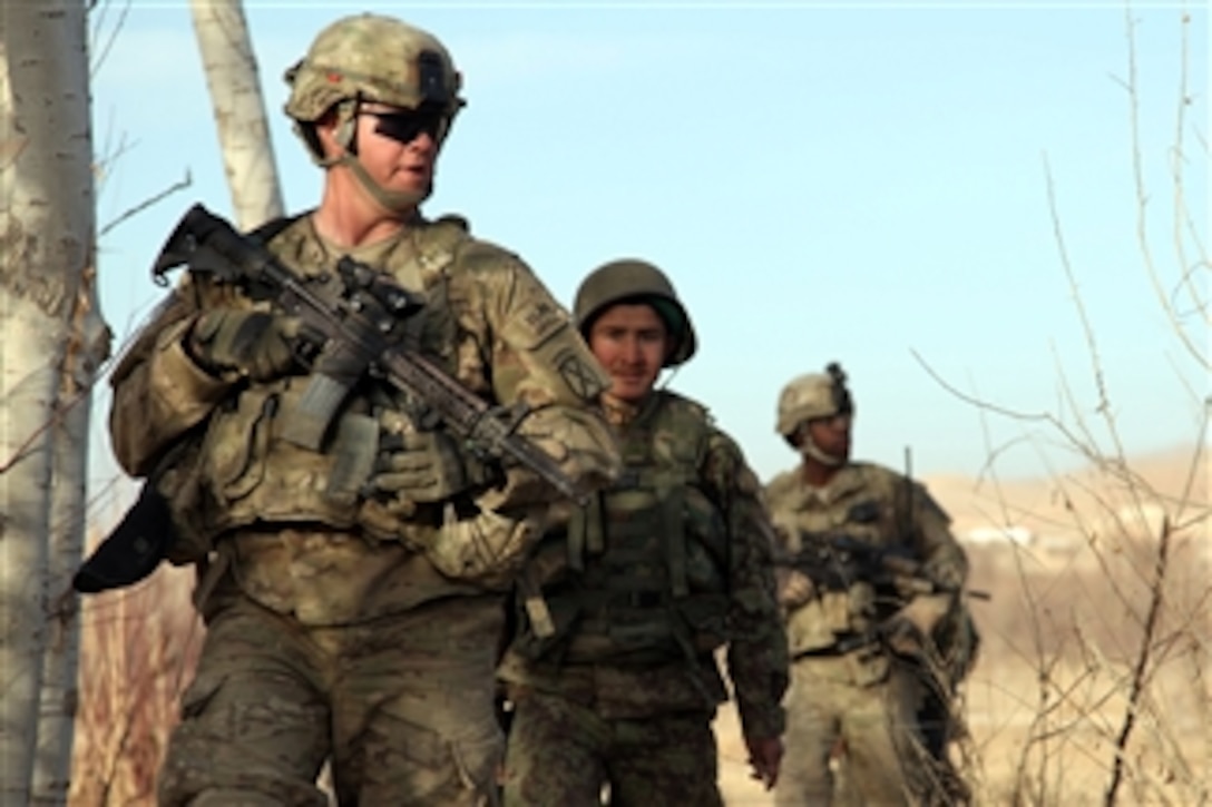 U.S. Army Spc. Conner Elms (left), with 1st Platoon, Bravo Company, 2nd Battalion, 4th Infantry Regiment, 4th Brigade Combat Team, 10th Mountain Division, and an Afghan National Army soldier (2nd from left) patrol outside the town of Shekhabad in Wardak province, Afghanistan, on Dec. 20, 2010.  