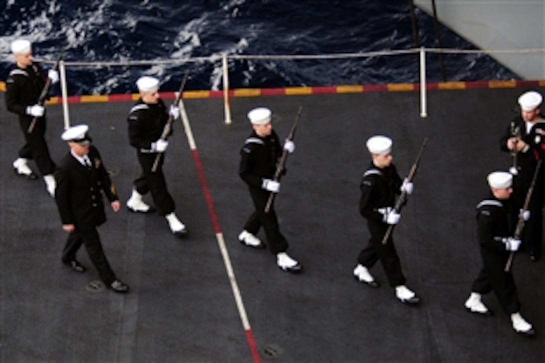 The rifle detail marches during a burial at sea aboard the aircraft carrier USS Carl Vinson, Dec. 27, 2010. The Carl Vinson and Carrier Air Wing 17 are on a deployment to the U.S. 7th and U.S. 5th Fleet areas of responsibility.