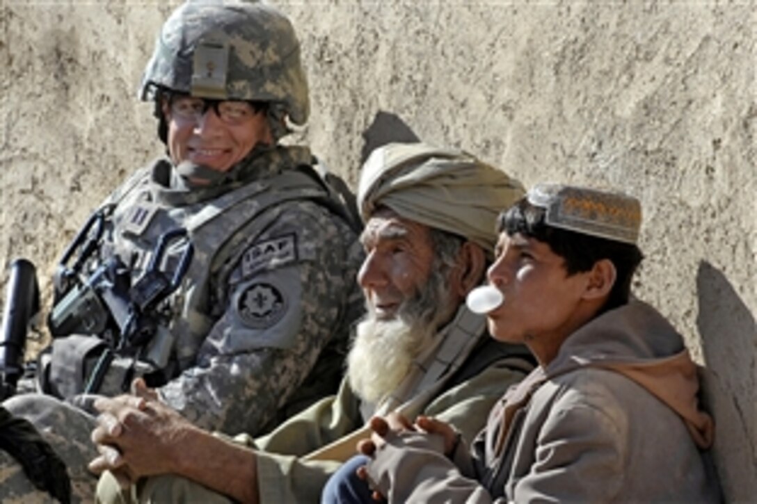 U.S. Air Force Capt. Ryan Weld talks with villagers during a wroowali, or brotherhood, mission to Bakorzai village, Afghanistan, Dec. 22, 2010. Weld, an intelligence officer is assigned to Provincial Reconstruction Team Zabul. Wroowali missions are designed to bring the Afghan people closer to their government.