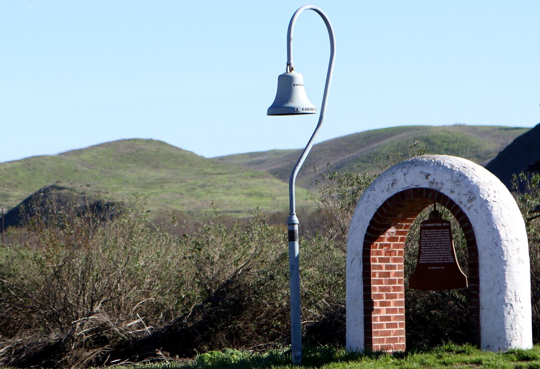 Along Camp Pendleton’s Vandegrift Boulevard stands one of California’s many historic El Camino Real bells that has been around long before any Marine or sailor occupied the land. The bell symbolizes the trail used by the Franciscan Padres on the journey to Northern California from Mexico in the 1800s.  The Padres were Catholic priests sent by the King of Spain to convert Native Americans of California to Catholicism, in order to become citizens of Spain. The bell on base stands where the trail crosses Vandegrift Boulevard, just inland of the main gate.