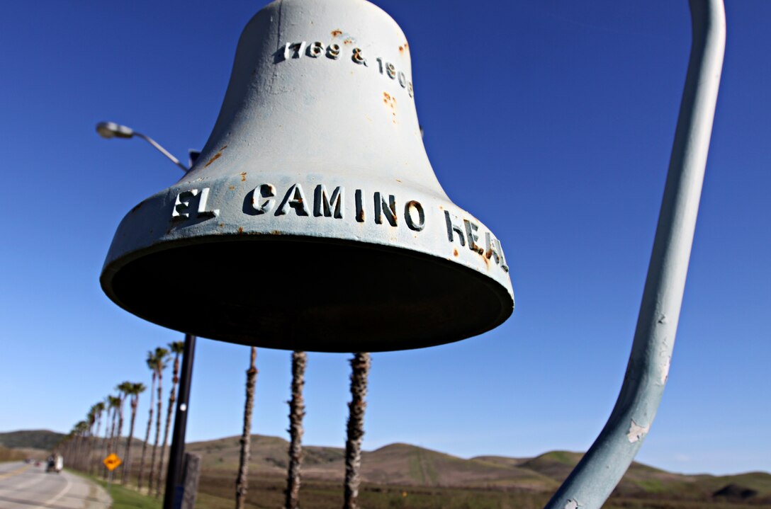 Along Camp Pendleton’s Vandegrift Boulevard stands one of California’s many historic El Camino Real bells that has been around long before any Marine or sailor occupied the land. The bell symbolizes the trail used by the Franciscan Padres on the journey to Northern California from Mexico in the 1800s.  The Padres were Catholic priests sent by the King of Spain to convert Native Americans of California to Catholicism, in order to become citizens of Spain. The bell on base stands where the trail crosses Vandegrift Boulevard, just inland of the main gate.