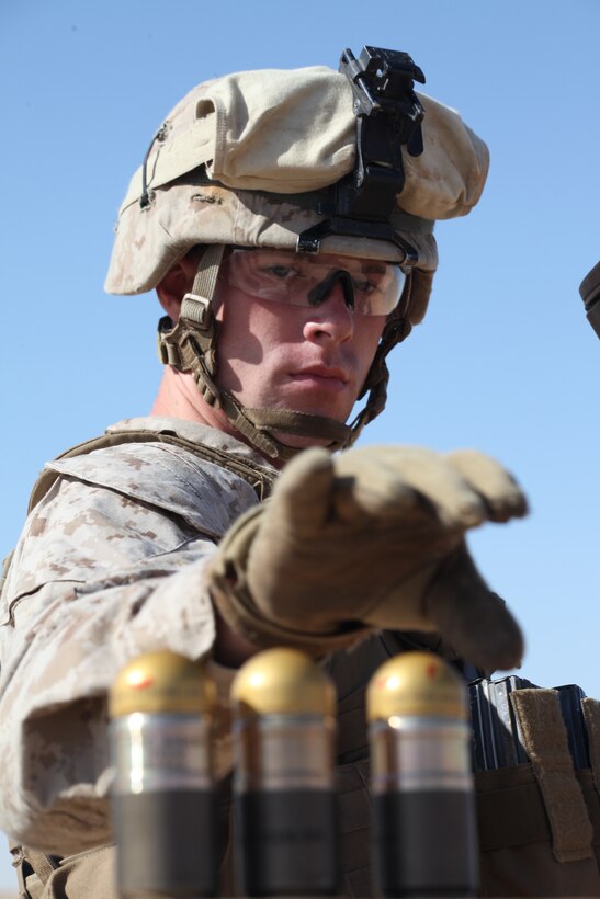 CAMP BUEHRING, Kuwait (Dec. 29, 2010) Cpl. Tim Sawyer, a vehicle commander with Combined Anti-armor Platoon, Weapons Company, Battalion Landing Team 3/8, 26th Marine Expeditionary Unit (MEU), reaches for a high explosive round to load into an M32A1 grenade launcher during a live-fire exercise at Camp Buehring, Kuwait, Dec. 29. Elements of 26th MEU debarked the ships of Kearsarge Amphibious Ready Group to conduct sustainment training. (USMC photo by Sgt. Jesse J. Johnson/Released)