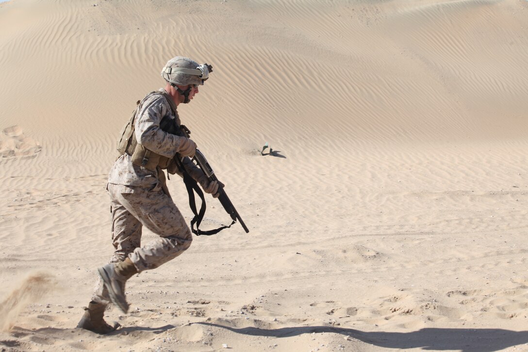 CAMP BUEHRING, Kuwait (Dec. 29, 2010) Cpl. Patrick Gleason, a section chief with Weapons Platoon, Company L, Battalion Landing Team 3/8, 26th Marine Expeditionary Unit (MEU), runs to the first position during an M500 shotgun live-fire exercise at Camp Buehring, Kuwait, Dec. 29. Elements of 26th MEU debarked the ships of Kearsarge Amphibious Ready Group to conduct sustainment training. (USMC photo by Sgt. Jesse J. Johnson/Released)