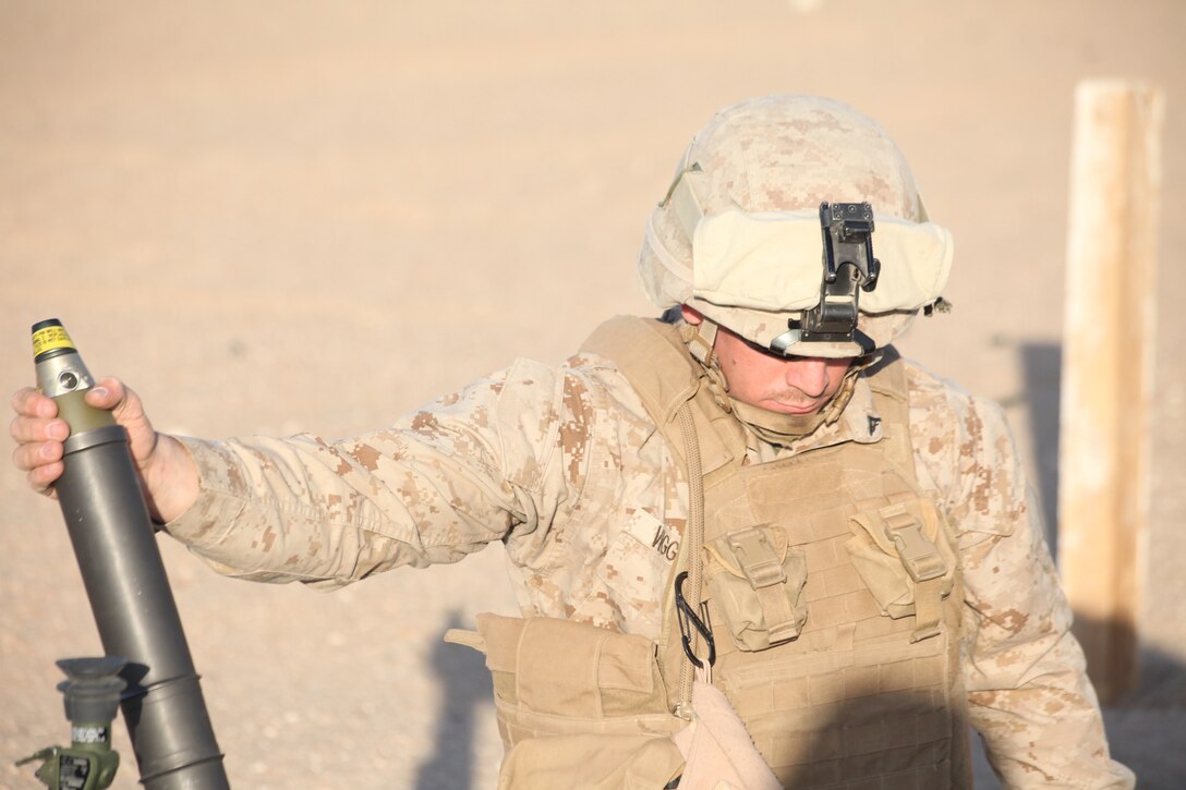 CAMP BUEHRING, Kuwait (Dec. 29, 2010) Lance Cpl. Michael Viggiano, a gunner with Weapons Platoon, Company L, Battalion Landing Team 3/8, 26th Marine Expeditionary Unit (MEU), holds a round at half-load in a 60mm mortar during a live-fire exercise at Camp Buehring, Kuwait, Dec. 29. Elements of 26th MEU debarked the ships of Kearsarge Amphibious Ready Group to conduct sustainment training. (USMC photo by Sgt. Jesse J. Johnson/Released)