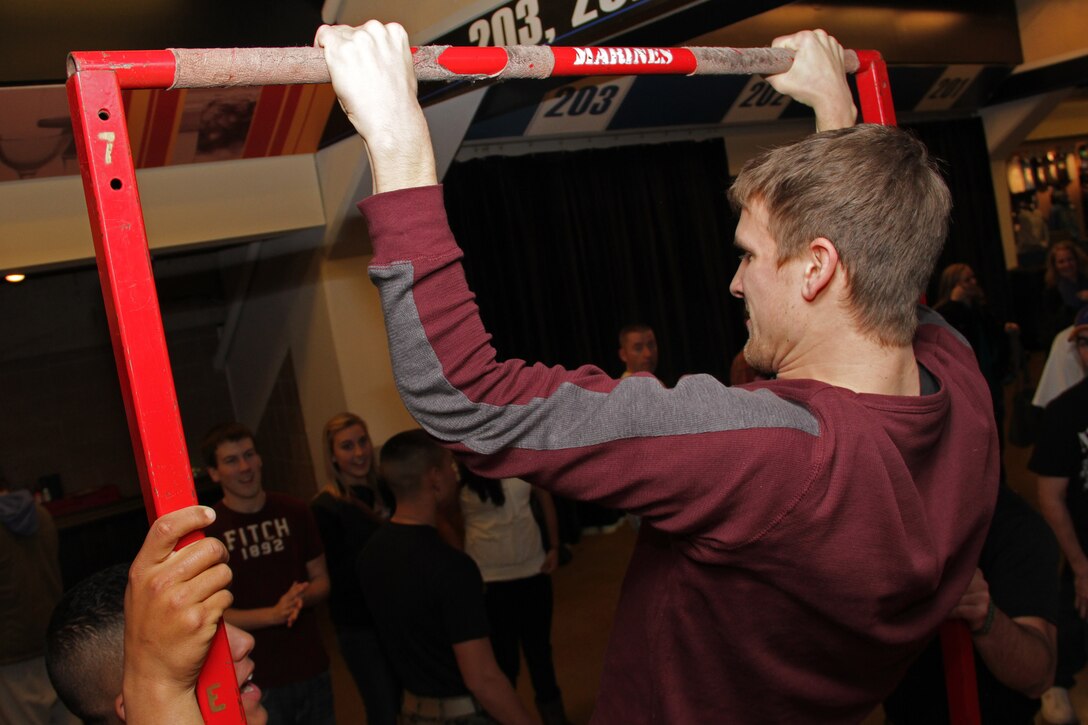 Alex Wheeler, a 19-year-old student at the University of Minnesota, struggles to perform his final pull-up while taking the Marine Corps Challenge at the Target Center where the Minnesota Timberwolves took on the Denver Nuggets Dec. 29. Wheeler is from Burnsville, Minn. For more photos of the event, visit the Recruiting Station Twin Cities fan page at www.facebook.com/rstwincities.