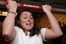 Brooke Selisker, 18, from Burnsville, Minn., increases her flexed-arm hang time by slowly falling from the bar while taking the Marine Corps Challenge at the Target Center where the Minnesota Timberwolves took on the Denver Nuggets Dec. 29. Wheeler received a Marine Corps water bottle for her efforts after hanging on the bar for 57 seconds. For more photos of the event, visit the Recruiting Station Twin Cities fan page at www.facebook.com/rstwincities.