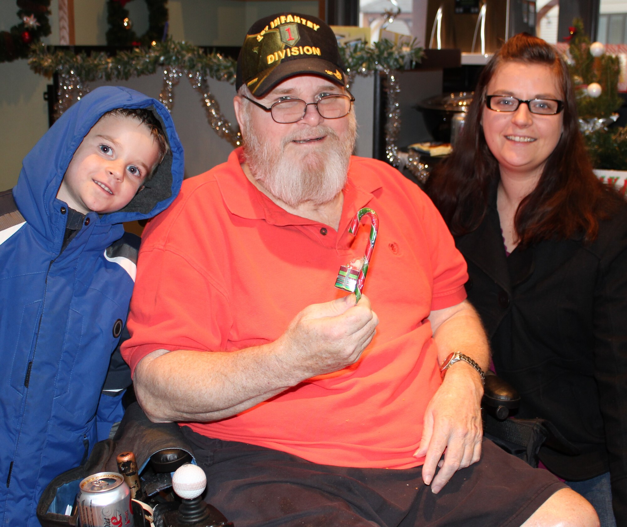 David Rohe, a U.S. Marine veteran, shows the candy that Staff Sgt. Heather Johnson and son, Dylan, gave to residents at the Missouri Veterans Home.  932nd Airlift Wing reservists donated almost $200 which was used to buy winter gloves, hats and other items. Sergeant Johnson, secretary of the Rising Six,  distributed clothing, candy and cookies to the veterans just before Christmas. This marks the second year that the 932nd AW Rising Six enlisted organization has provided gifts and vistited veterans at the facility in St. Louis, Mo.  (U.S. Air Force photo/Tech. Sgt. Dan Oliver) 
