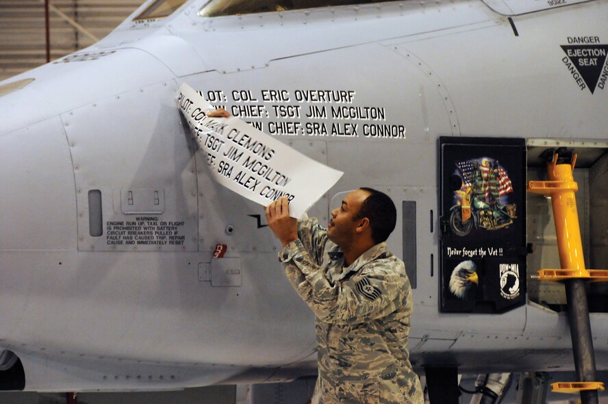 Tech. Sgt. Kellie Askew, 442nd Aircraft Maintenance Squadron crew chief, reveals the name of the new wing commander on an A-10 Thunderbolt II, aircraft tail number 79-0112, during the wing change-of-command ceremony, Dec. 4, 2010. During the ceremony, Col. Eric Overturf took charge of the 442nd Fighter Wing. The wing is an Air Force Reserve unit at Whiteman Air Force Base, Mo. (U.S. Air Force photo/Tech. Sgt. Tom Talbert)