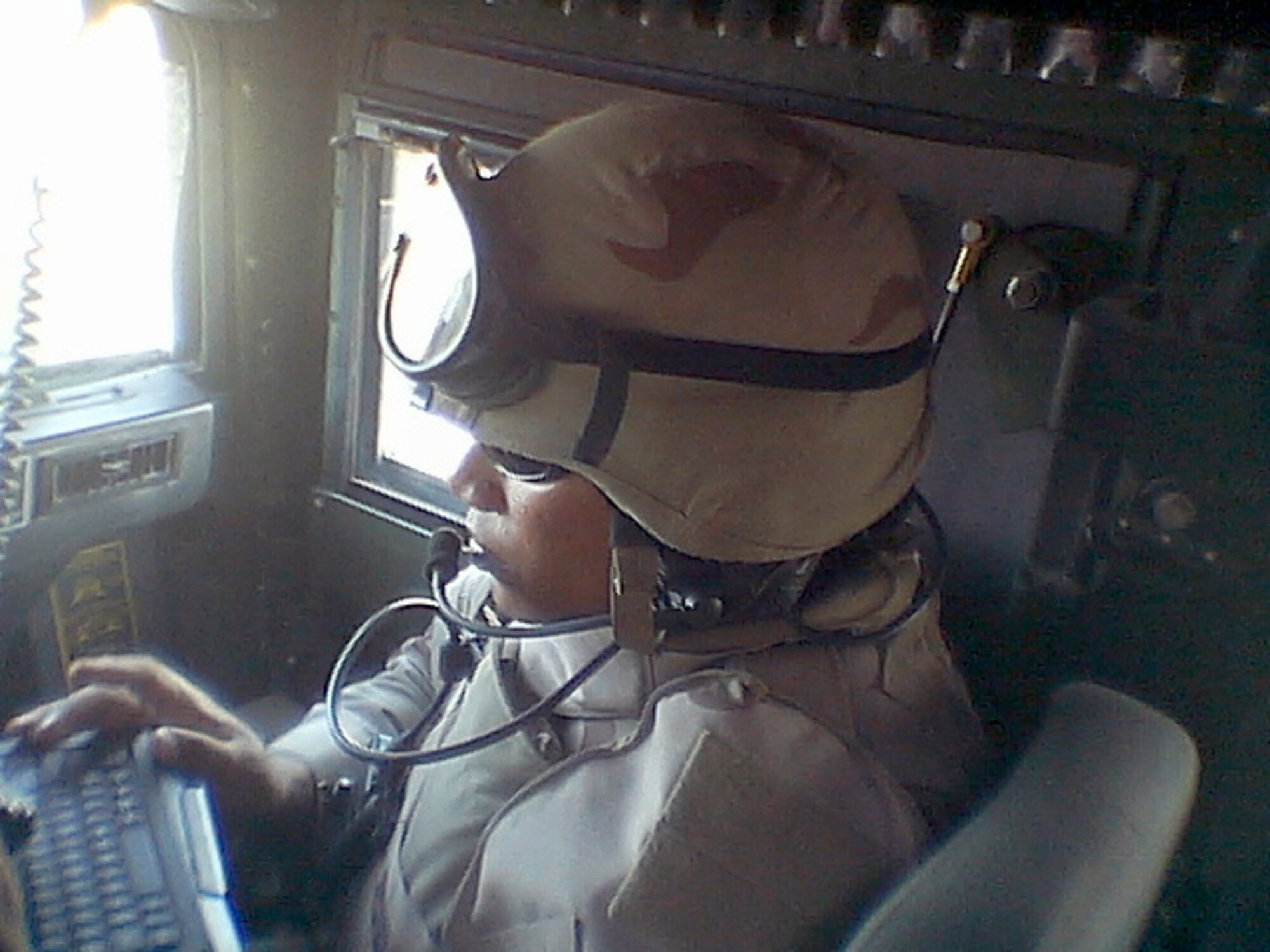 Tech. Sgt. Lorenzo Zapata sits at his convoy work station in a Humvee in 2007 in Iraq. Sergeant Zapata recently finished his time as a deployment transition center facilitator and has returned to regular duty at the 1st Combat Communications Squadron at Ramstein Air Base, Germany. (Courtesy Photo)