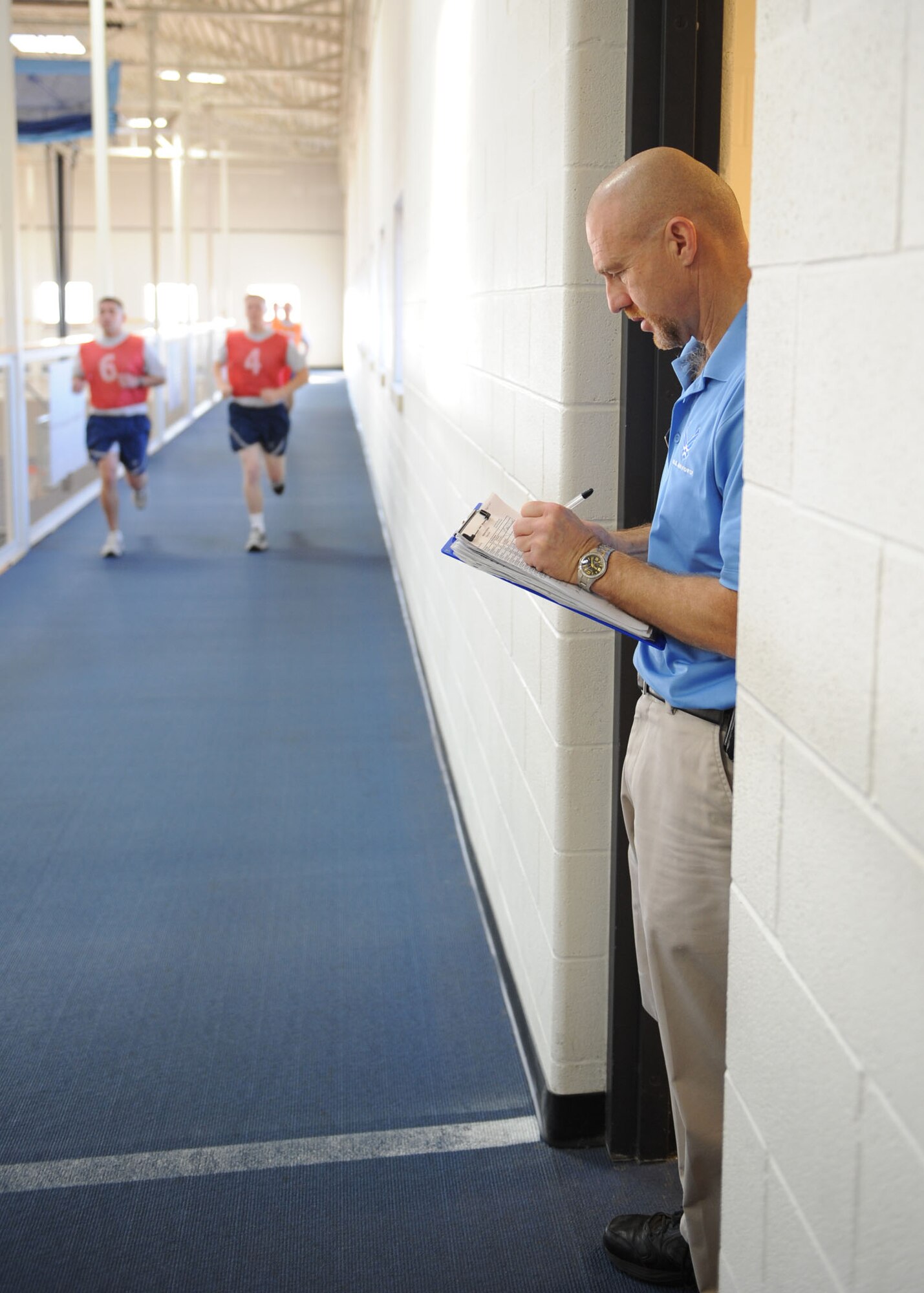 DYESS AIR FORCE BASE, Texas – Kenneth Simonton, physical training test administrator, keeps track of runners Dec. 29 at the fitness center here. It’s important for Airmen to stay in shape so when the time comes they are fit for deployment.  PT tests can be scheduled through the Health and Wellness Center, located inside the gym. (U.S Air Force photo/ Airman 1st Class Shannon Hall) 