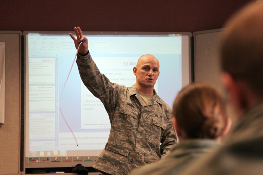 The 911th Airlift Wing fitness program manager, Master Sgt. Paul McInnis, instructs physical training leaders (PTLs), December 30, 2010, about the recent policy changes to the Air Force Fitness Program (AFI 36-2905).  The changes outlined in the Fitness Program emphasize new guidance measures and the USAF fitness test scoring chart.