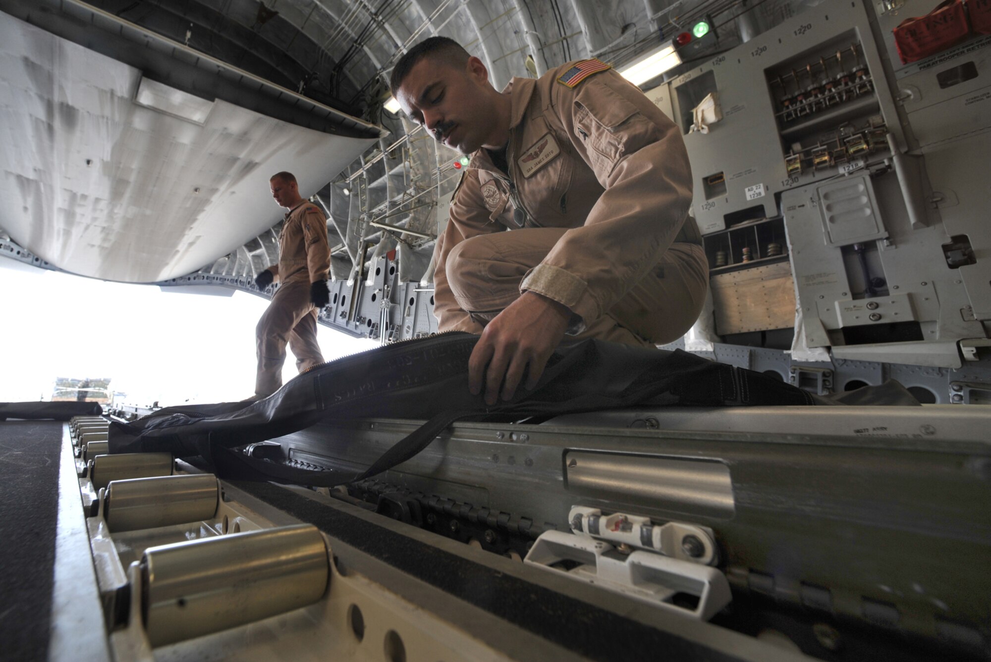 Senior Airman James Soto prepares the cargo compartment of a C-17 Globemaster III for 40 container delivery system bundles at Bagram Air Field, Afghanistan, April 5. Like Airman Soto, deployed from the 14th Airlift Squadron, Joint Base Charleston, S.C., four Reservists from the 446th Airlift Wing, Joint Base Lewis-McChord, Wash., have deplolyed to support airdrop and airland mission for Operation New Dawn in Southwest Asia. (U.S. Air Force photo/Staff Sgt. Quinton Russ)