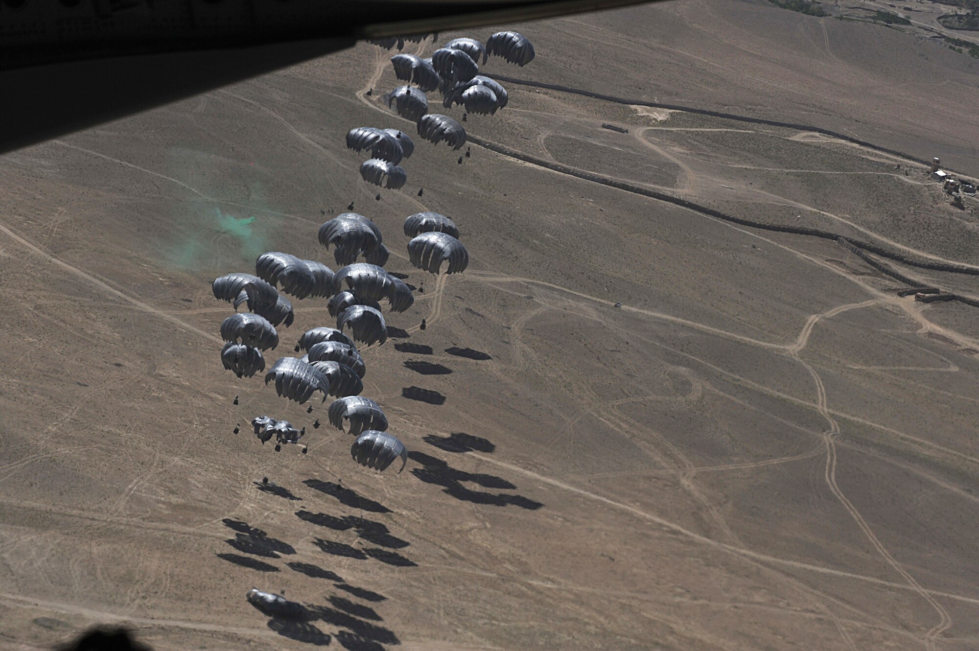 Container delivery system bundles float down to a marked area after being air dropped from a C-17 Globemaster III over Afghanistan, April 5. The CDS bundles are filled with food and water to re-supply U.S. Forces.  Four Reserve loadmasters from the 446th Airlift Wing, Joint Base Lewis-McChord, Wash., are deploying to Southwest Asia to conduct airdrop and airland missions with the 816th Expeditionary Airlift Squadron. (U.S. Air Force photo/Staff Sgt. Quinton Russ)